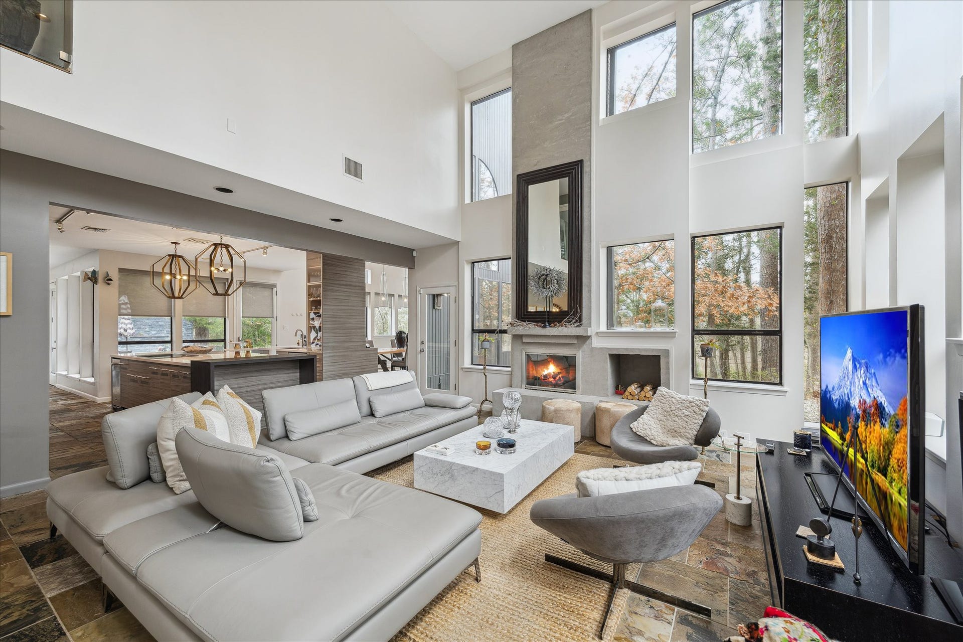 23414 Holly Hollow Street, Tomball, TX 77377 Incredible floor-to-ceiling windows frame sweeping views of the propertys natural surroundings, filling the home with abundant natural light.