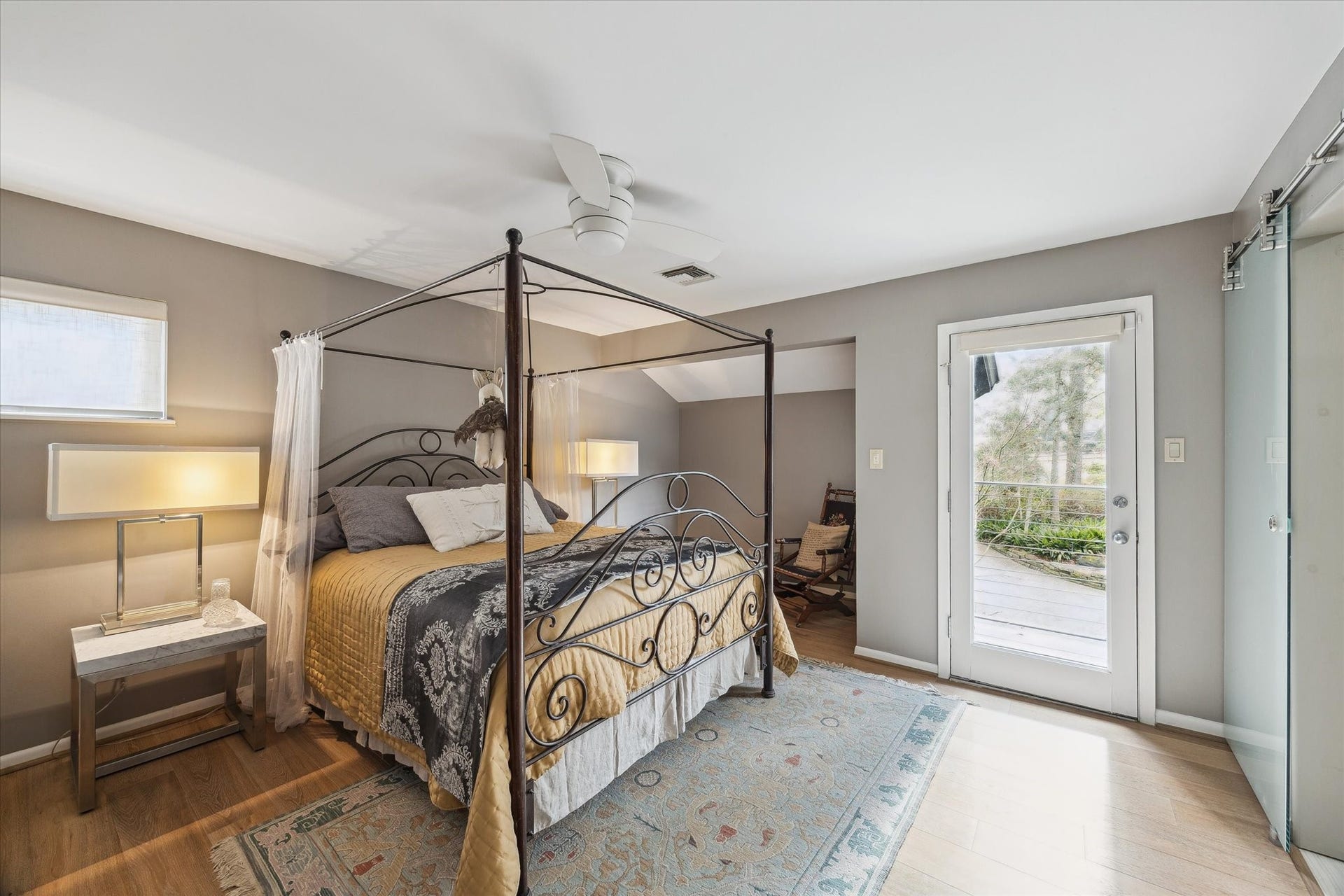 23414 Holly Hollow Street, Tomball, TX 77377 Secondary bedroom with balcony access, tranquil treetop views, and convenient connection to the Jack & Jill bath.