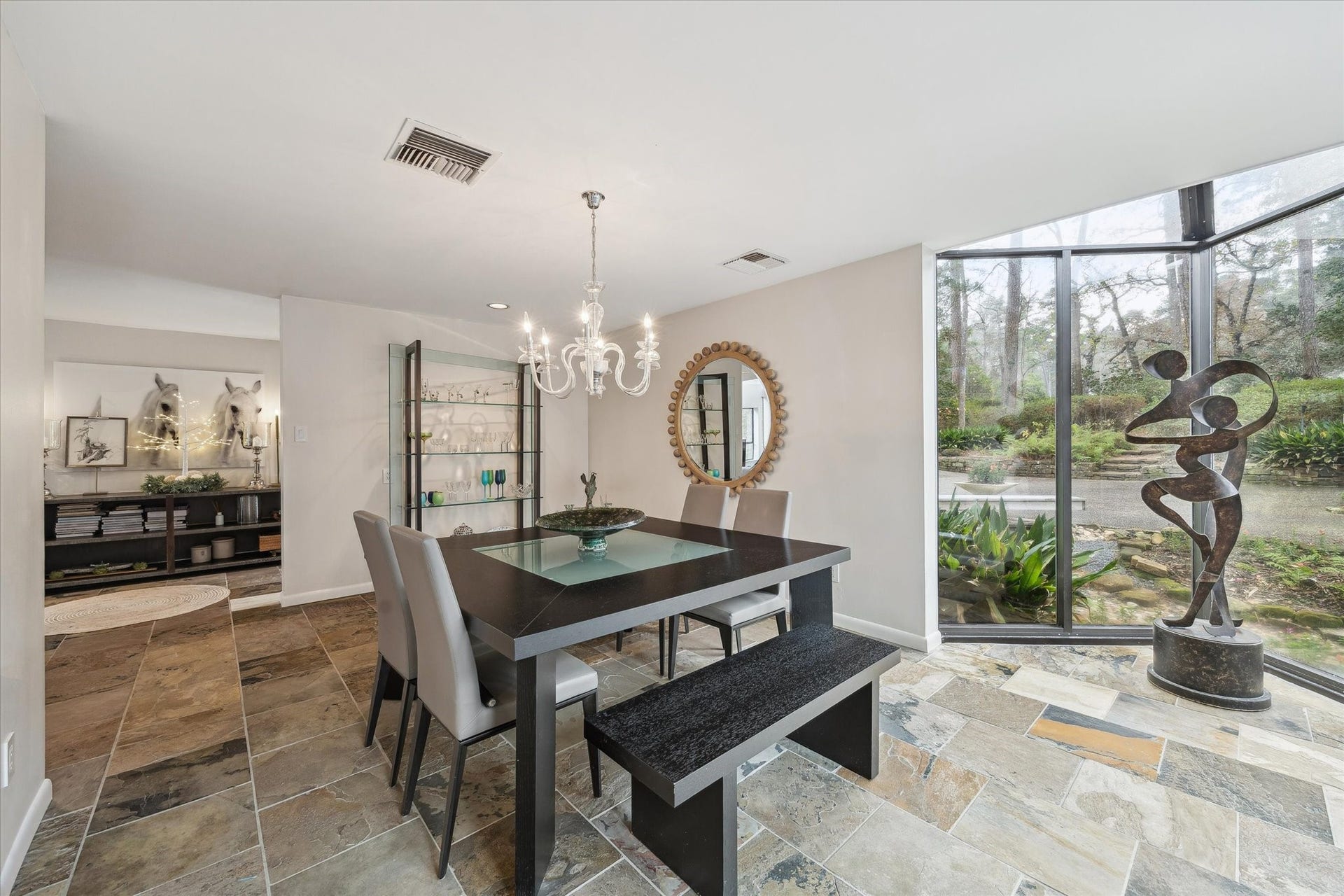 23414 Holly Hollow Street, Tomball, TX 77377 Elegant dining space illuminated by natural light, offering serene views and a seamless connection to the outdoors.