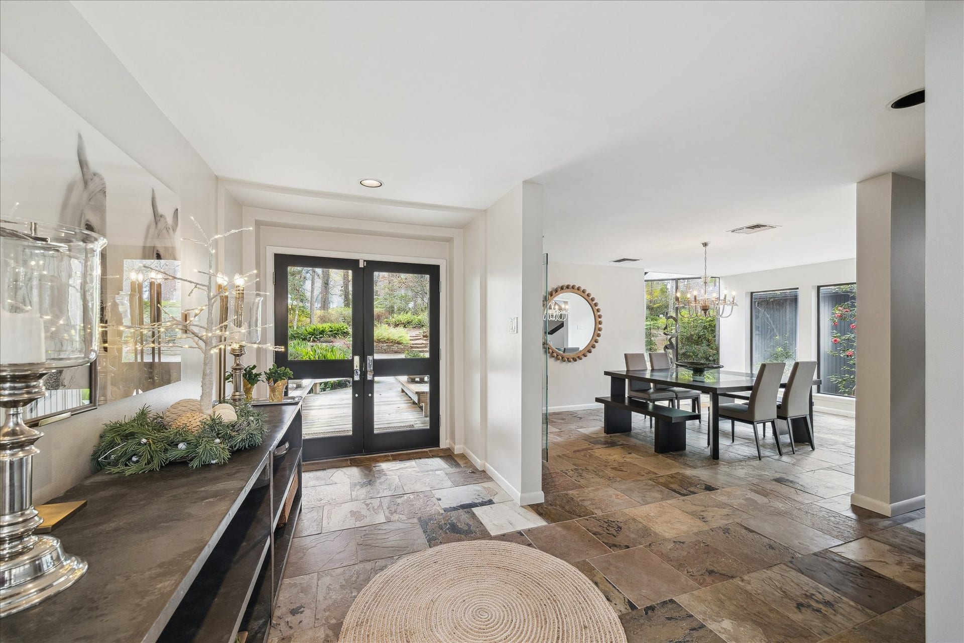 23414 Holly Hollow Street, Tomball, TX 77377 Welcome guests through the glass-inlaid double doors into a raised grand entryway, where abundant natural light, elegant architectural details, and a welcoming sense of arrival set the tone for the home.