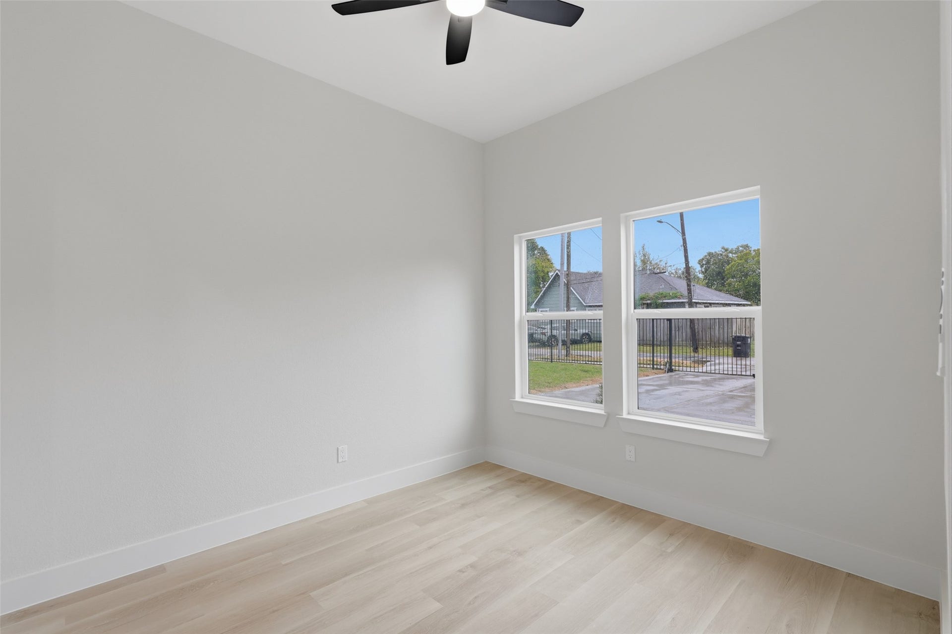 Bright and airy room featuring light LVP flooring, fresh white walls, and easy access to an adjoining private bathroom, perfect one of the four bedrooms facing the front entrance