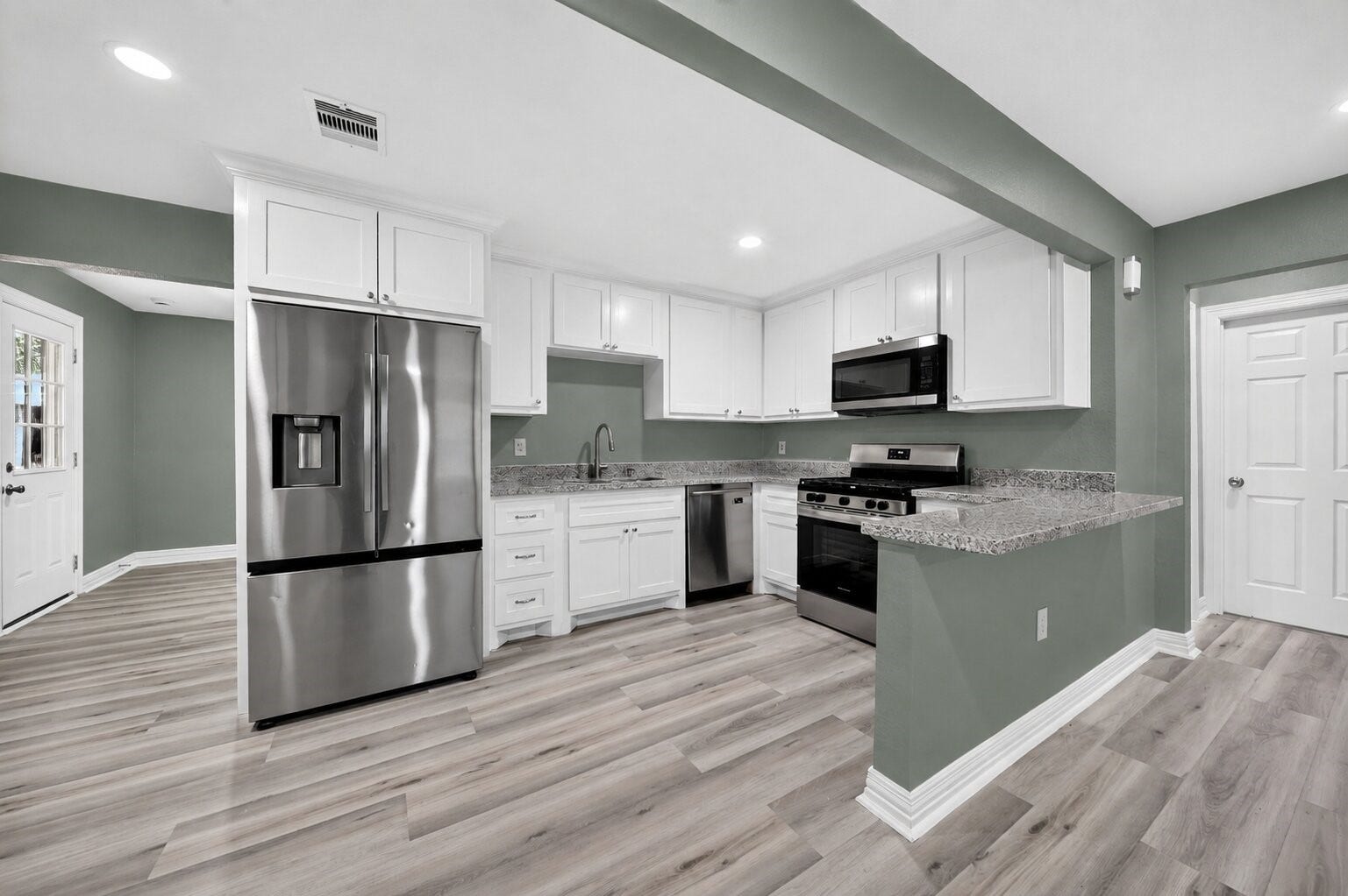 Kitchen with stainless appliances and granite counters