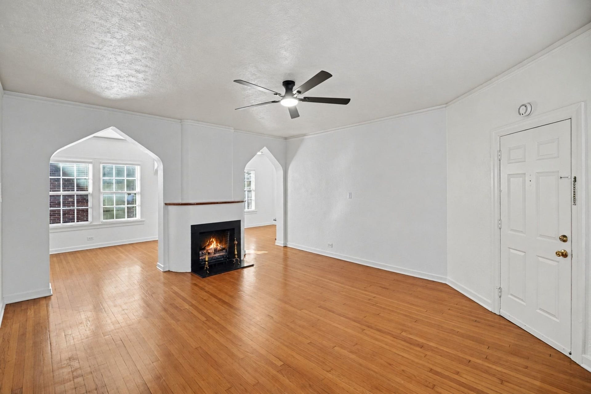 4408 Yoakum Boulevard, #4, Houston, TX 77006 The spacious living room has a mock fireplace and original wood floors.