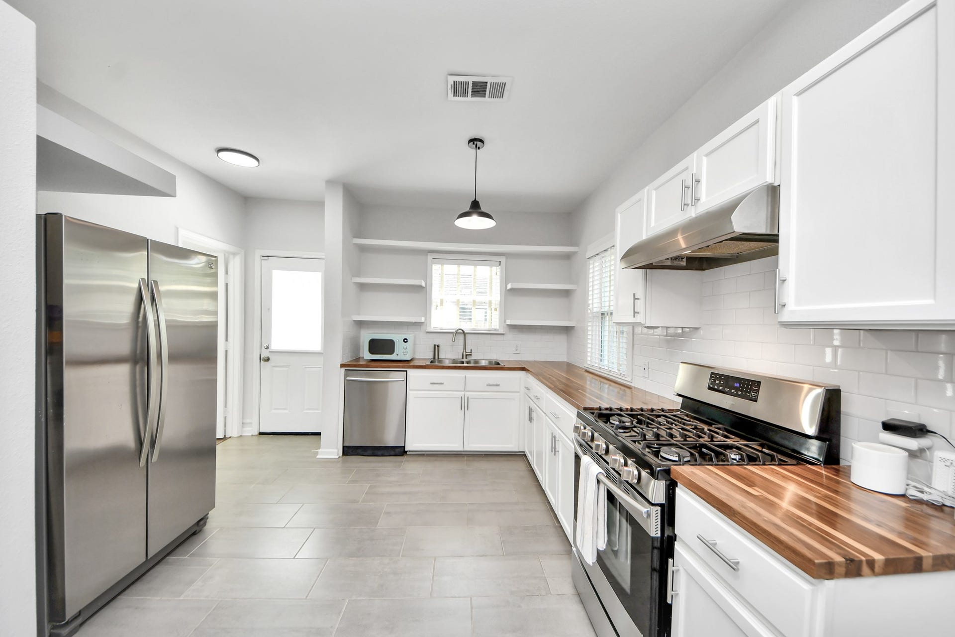 Blending classic character with everyday functionality, this inviting kitchen offers generous countertop space and ample storage for all your culinary needs.
