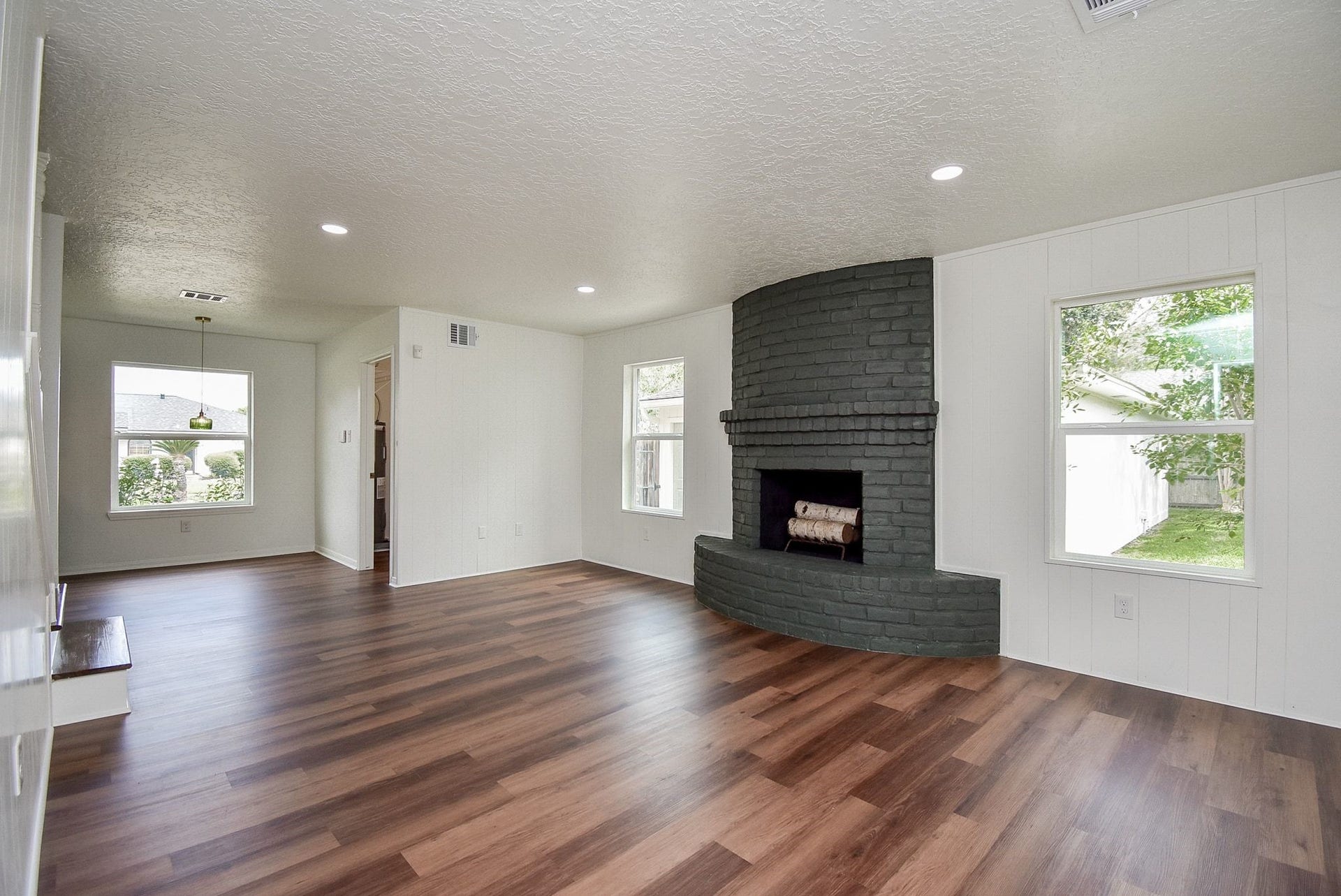 3303 Hilton Head Court, Missouri City, TX 77459 The family room has a wood burning fireplace flanked by two picture windows with views to the yard.