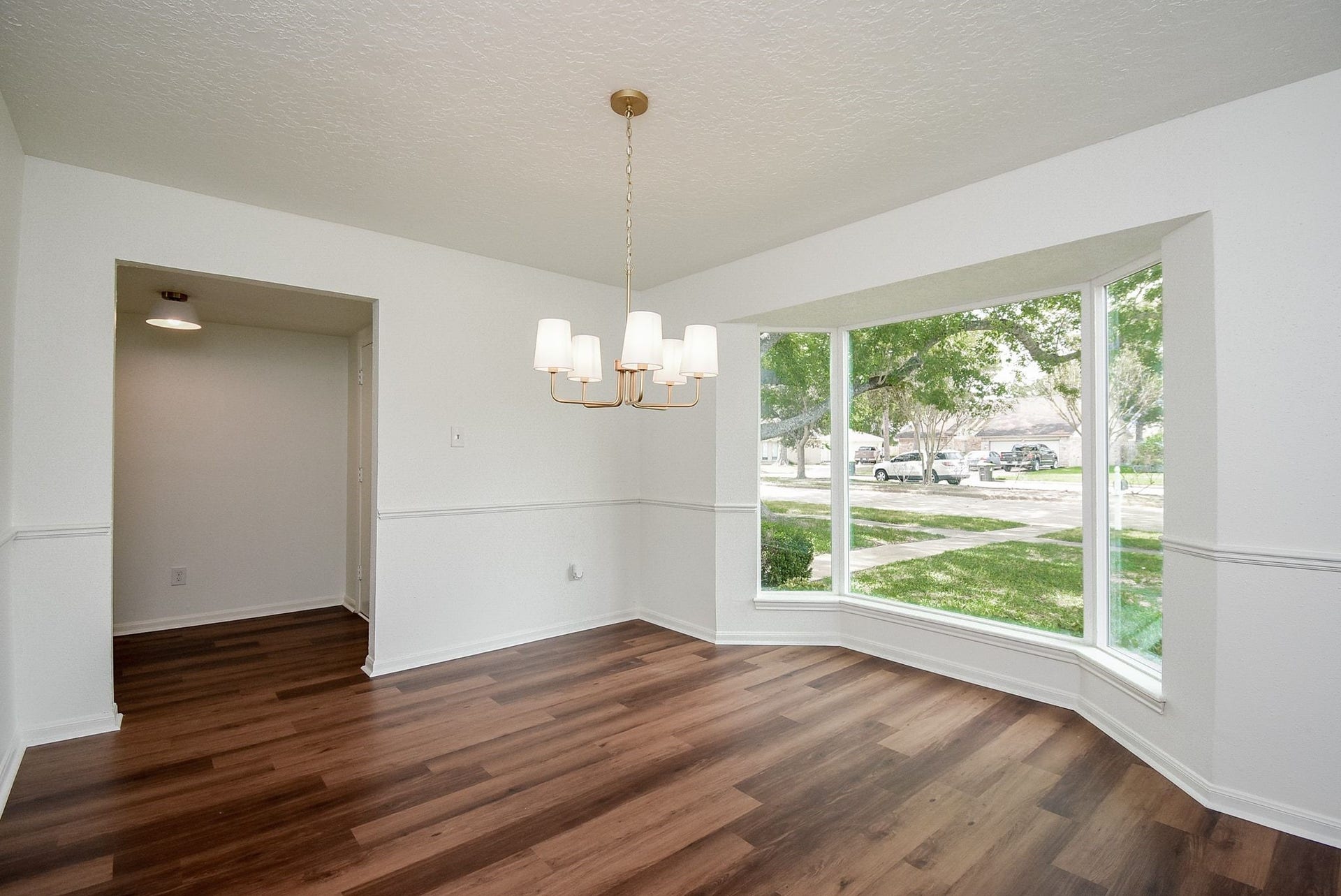 3303 Hilton Head Court, Missouri City, TX 77459 A second view of the pretty formal dining room showcases the chair rail molding and updated chandelier.