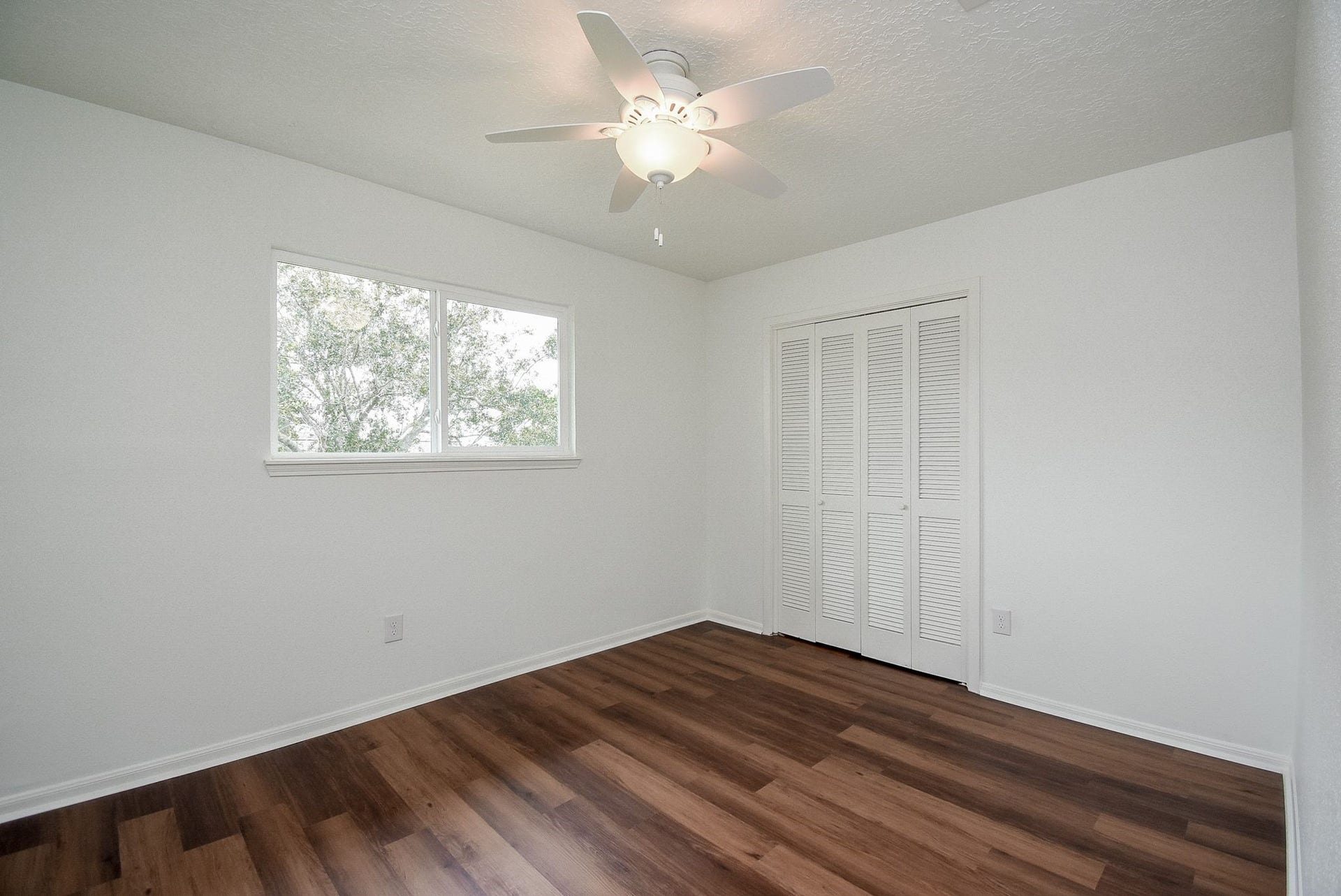 3303 Hilton Head Court, Missouri City, TX 77459 Bedroom two is located upstairs. The PVC waterproof flooring warms the room with tones. Light and bright with great wall space.
