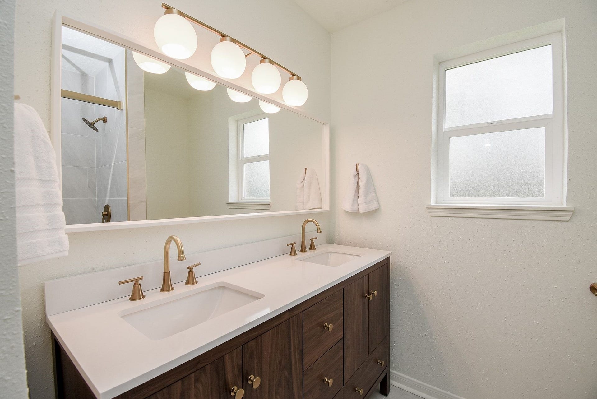 3303 Hilton Head Court, Missouri City, TX 77459 The primary bath with new vanity has double sinks, new hardware, countertop, mirror and lighting. Frosted glass window brings light in while keeping the privacy.