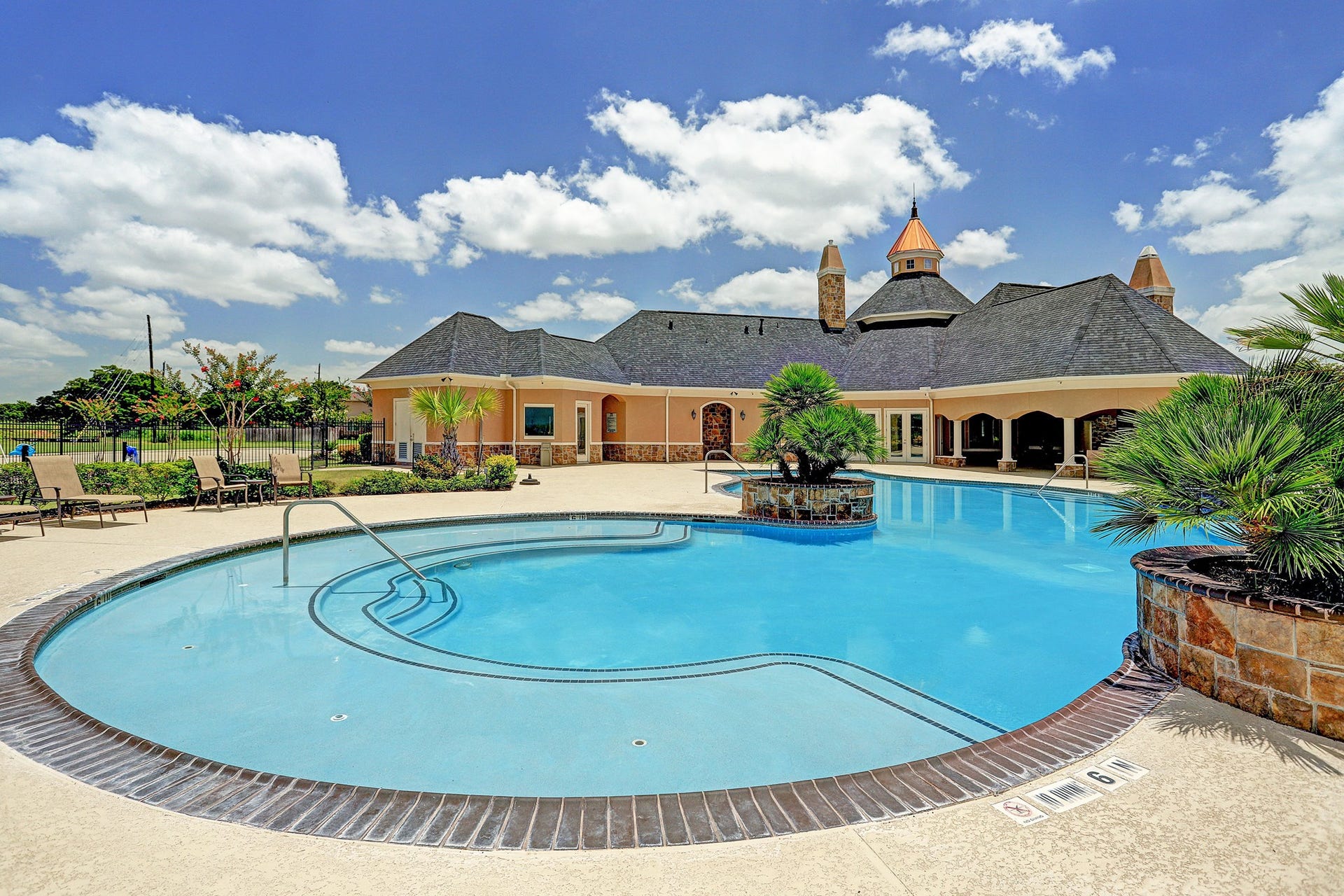 The neighborhood pool features a beach entry and several waterfalls. Enjoy a cool swim in the pristine waters.