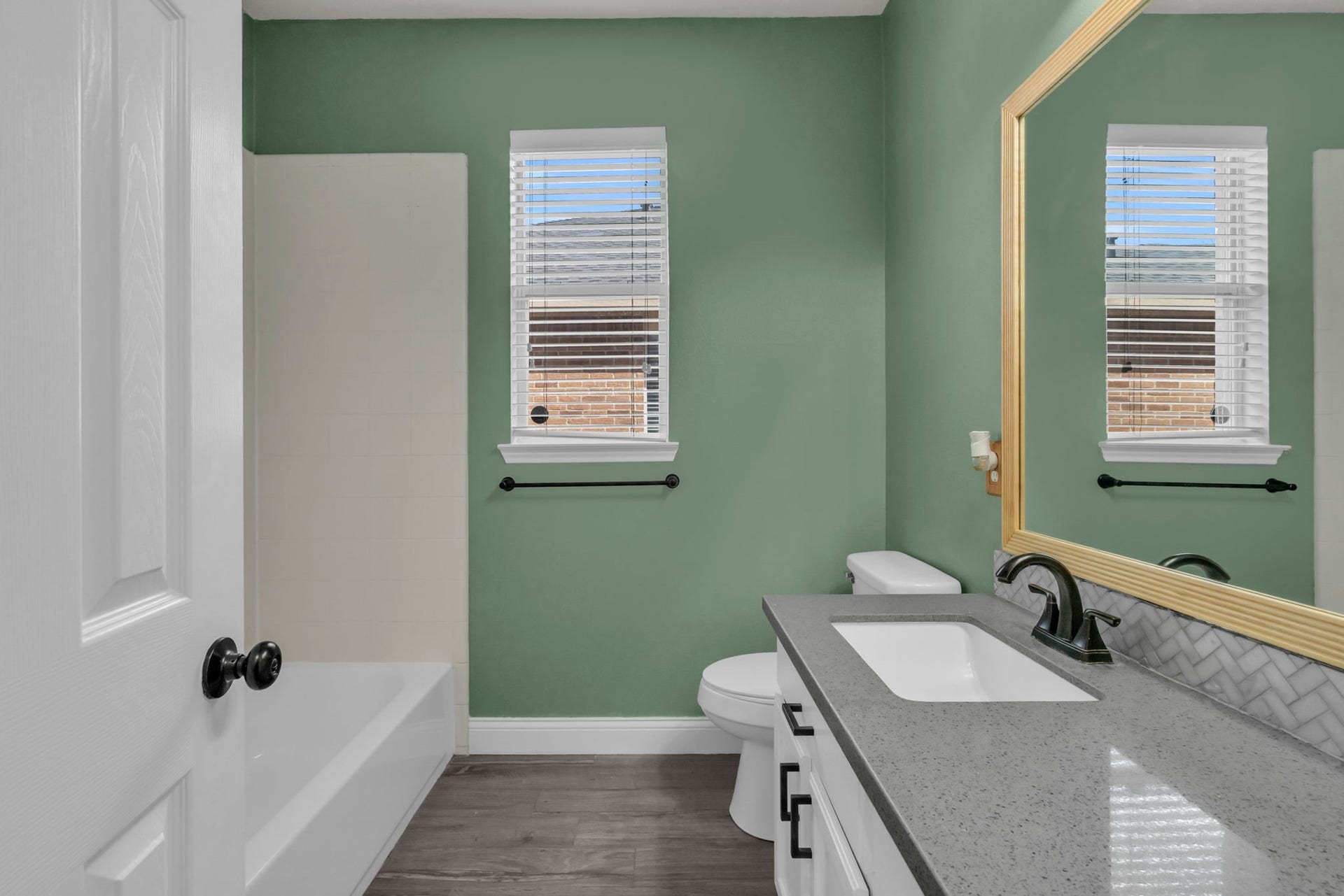 Secondary bathroom with a combination tub and shower.