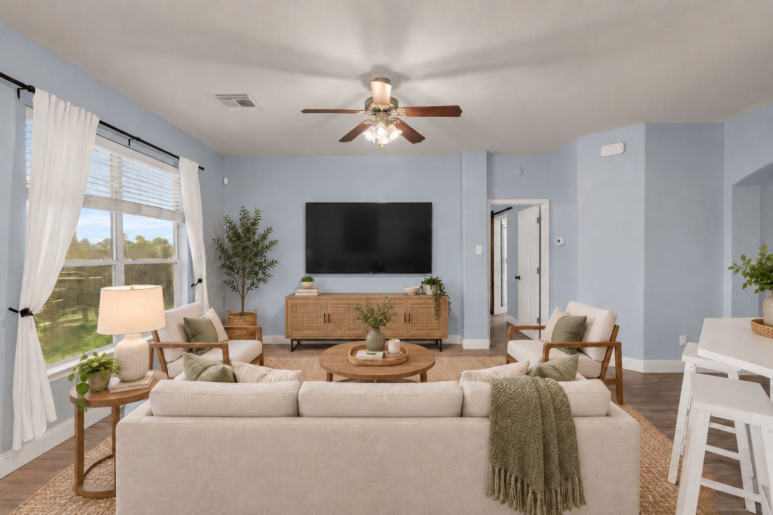 Charming living room with views of the backyard. (Virtually Staged)