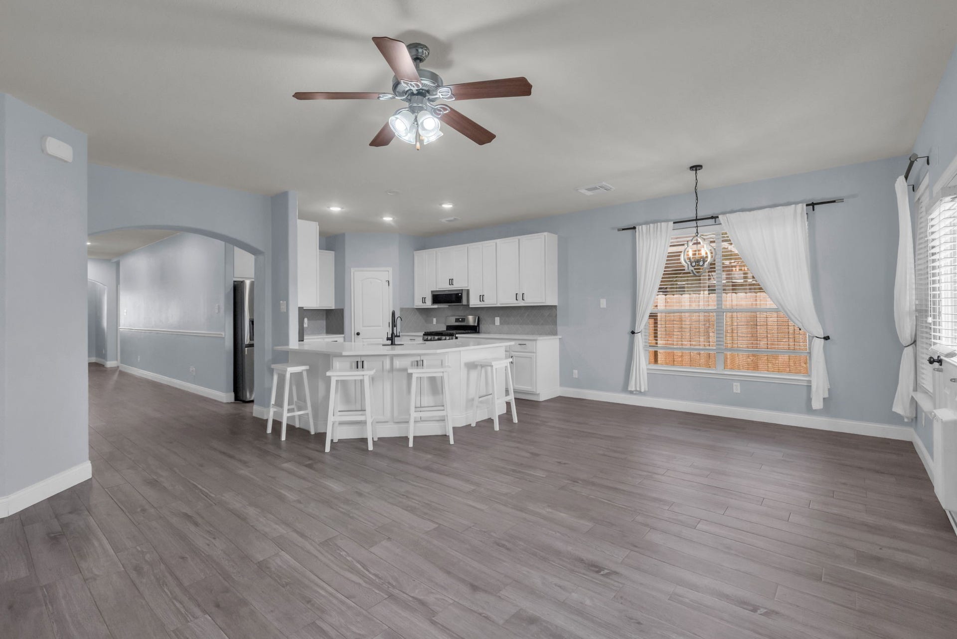 Spacious main living areas showcases the homes open floor plan, generous kitchen island, and bright breakfast nook overlooking the backyard.