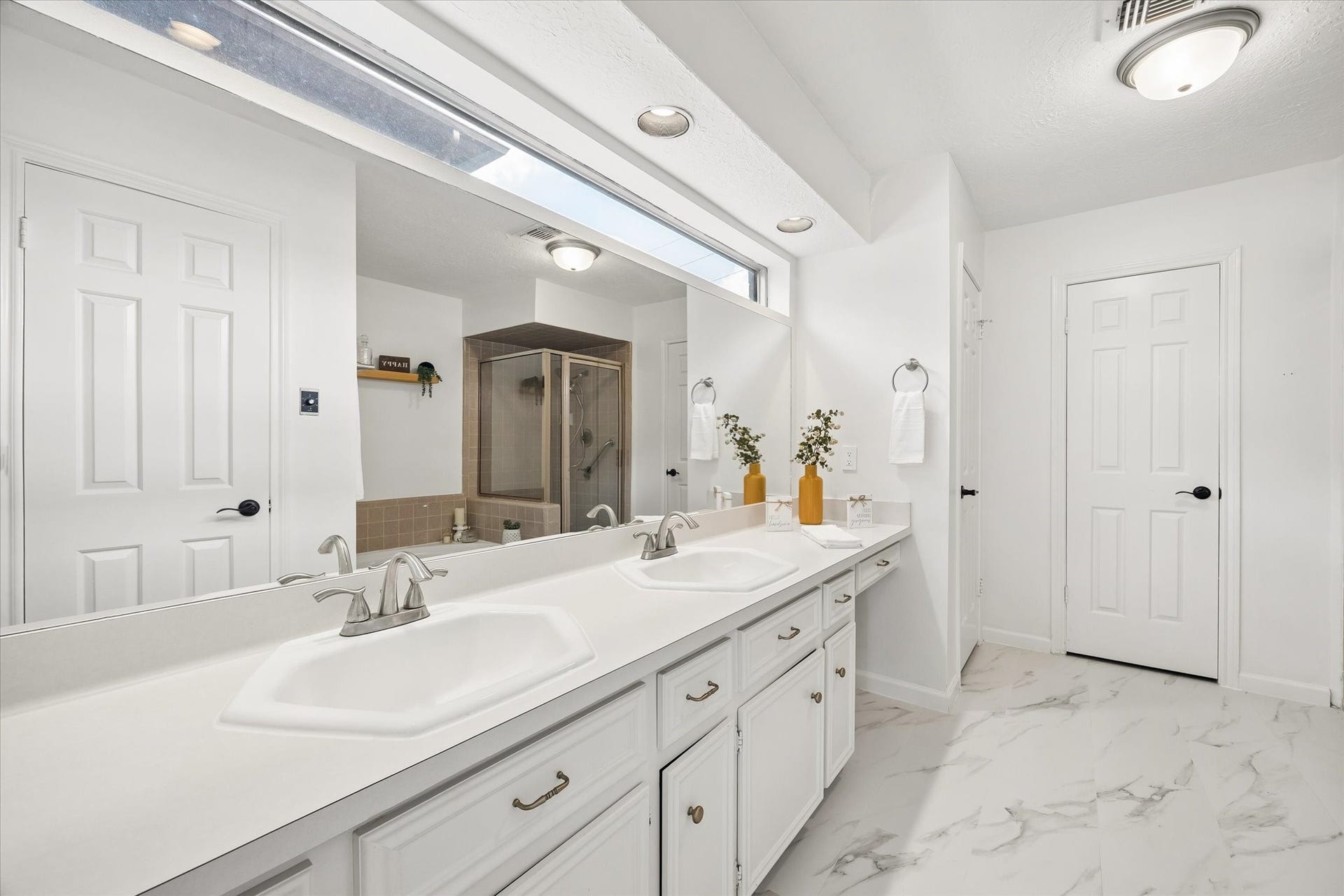Master bath with glass window letting natural light in while keeping your privacy