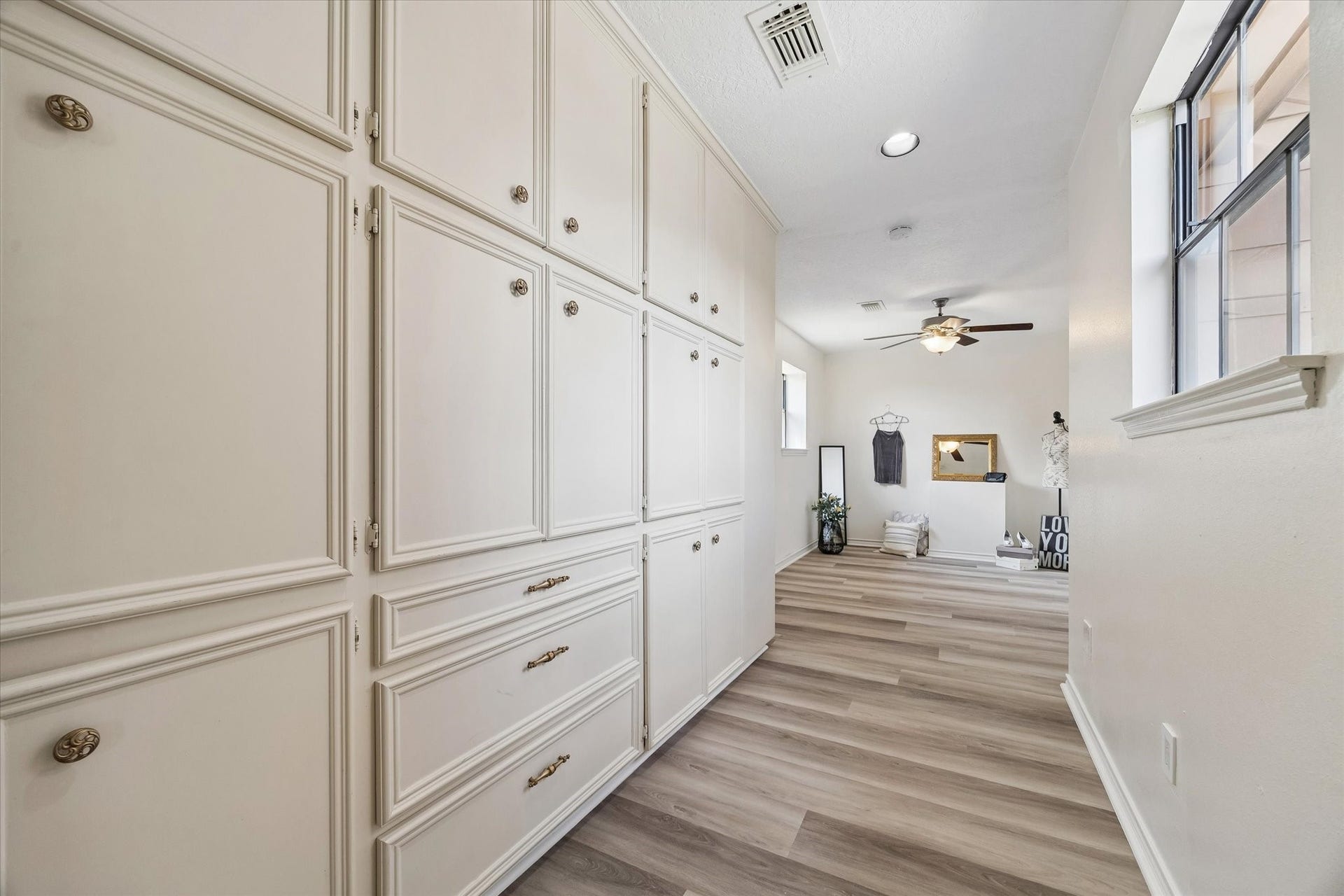 The hallway connecting the main house and the private second master bedroom comes with plenty of built in cabinets for your storage needs
