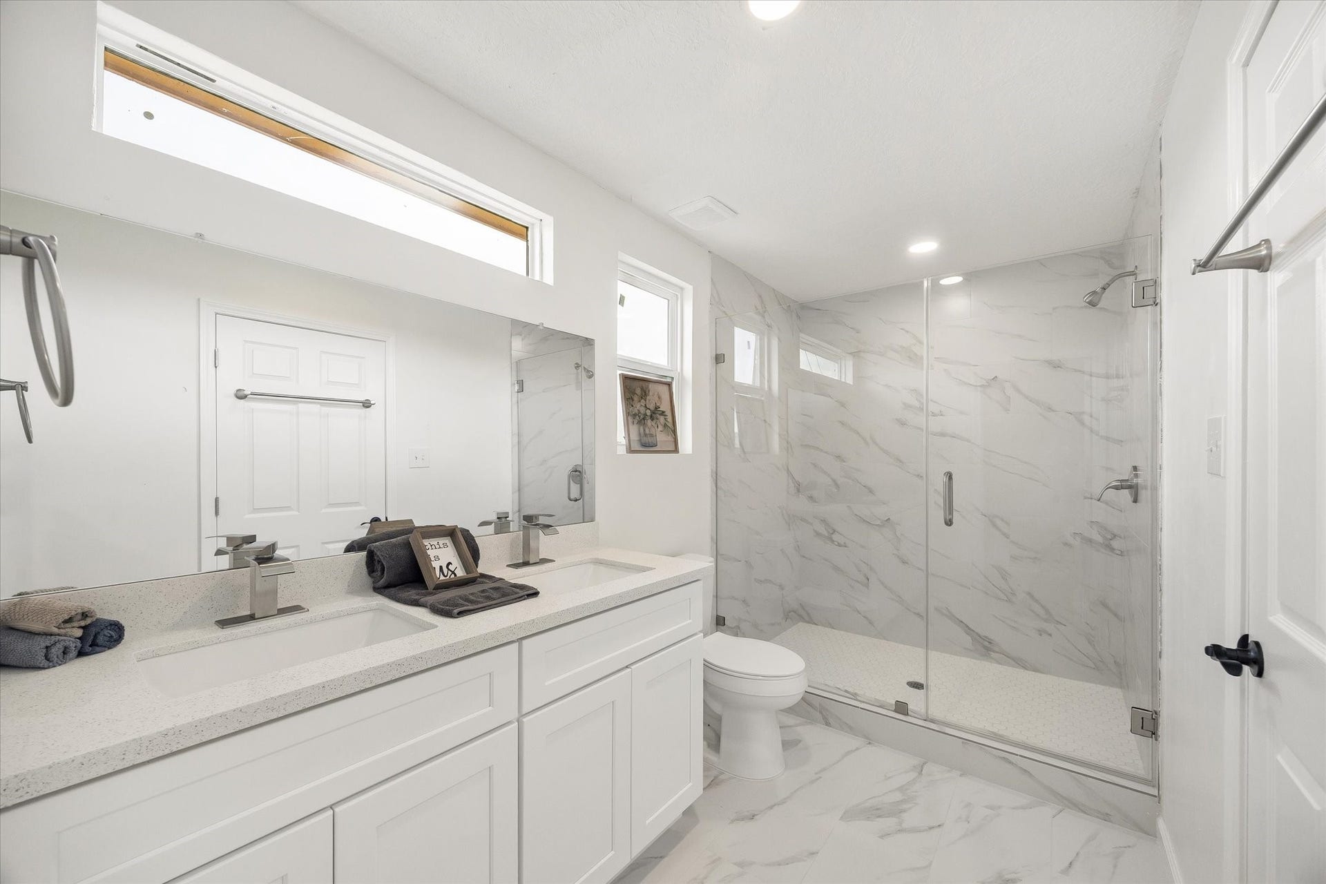 Brand new bathroom with glass door shower, double sinks, and walk in closet on your left (not pictured)