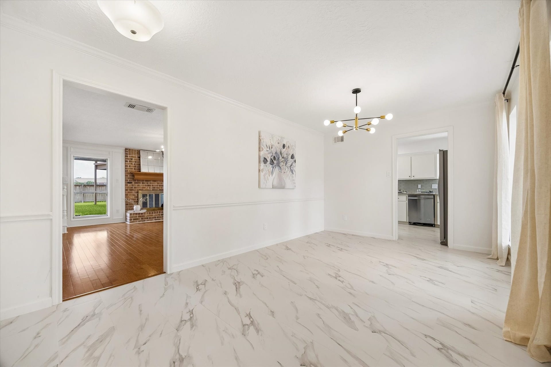 The natural light-filled dining room is steps away from the living room and kitchen, which is practical for both everyday life and hosting.