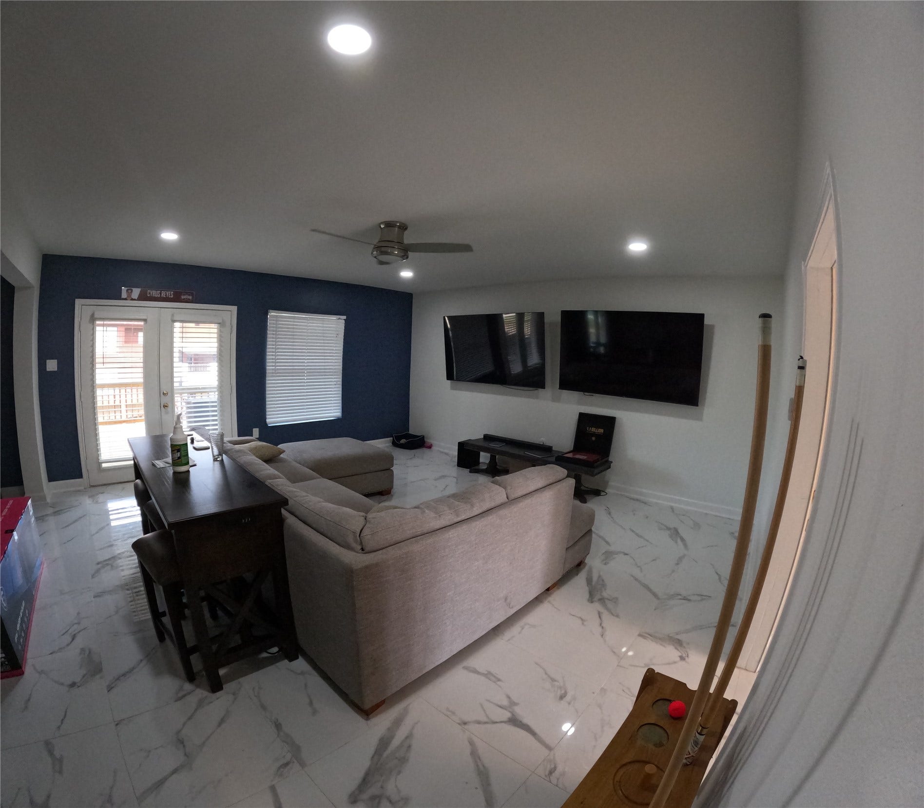 15 Harbour Drive, Nassau Bay, TX 77058 Living space on the second floor with white marble floors and twin flatscreens for entertaining