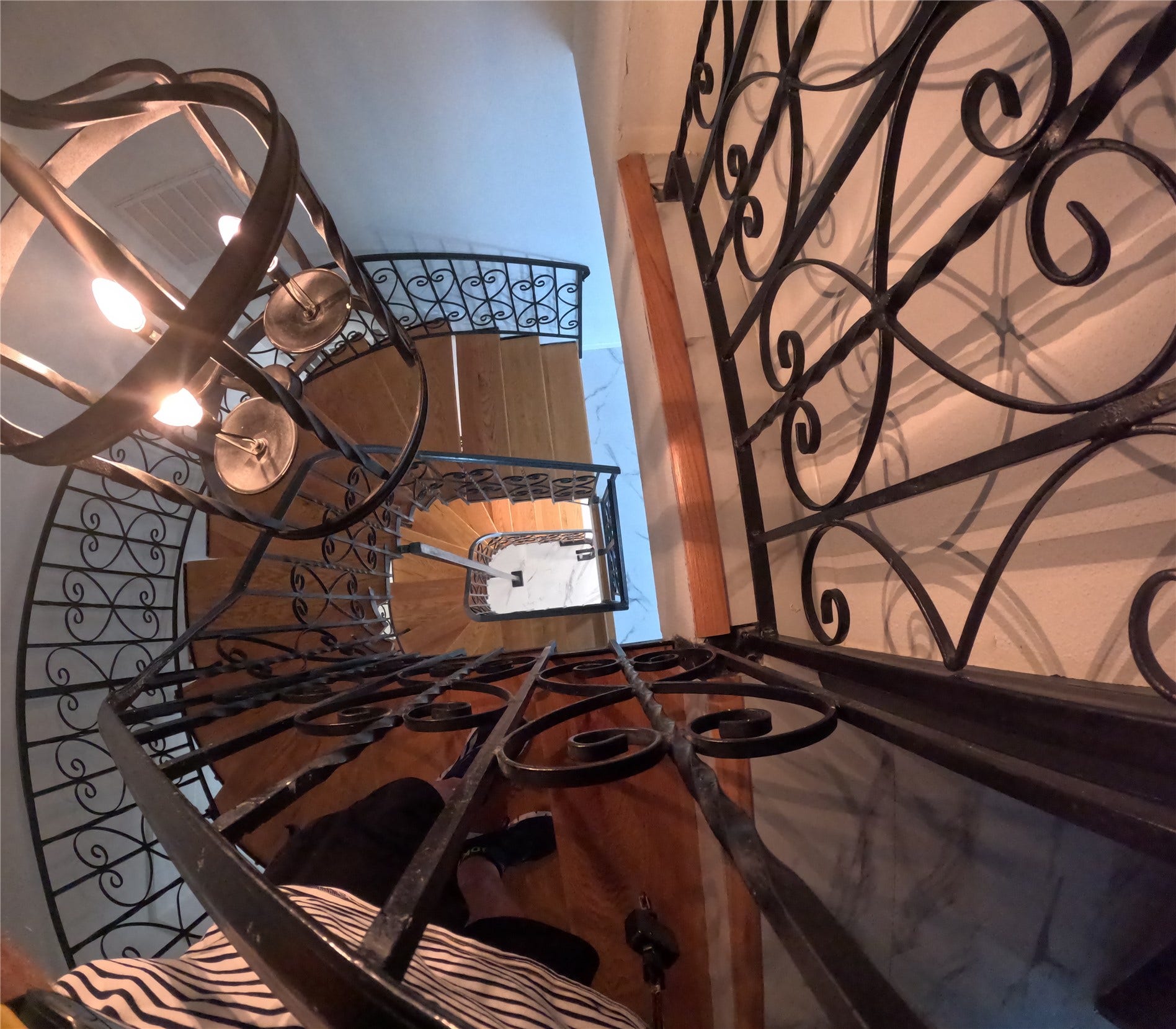 15 Harbour Drive, Nassau Bay, TX 77058 Looking down the curved wroght irn staircase that goes from top to bottom. The home has room for an elevator to be installed.