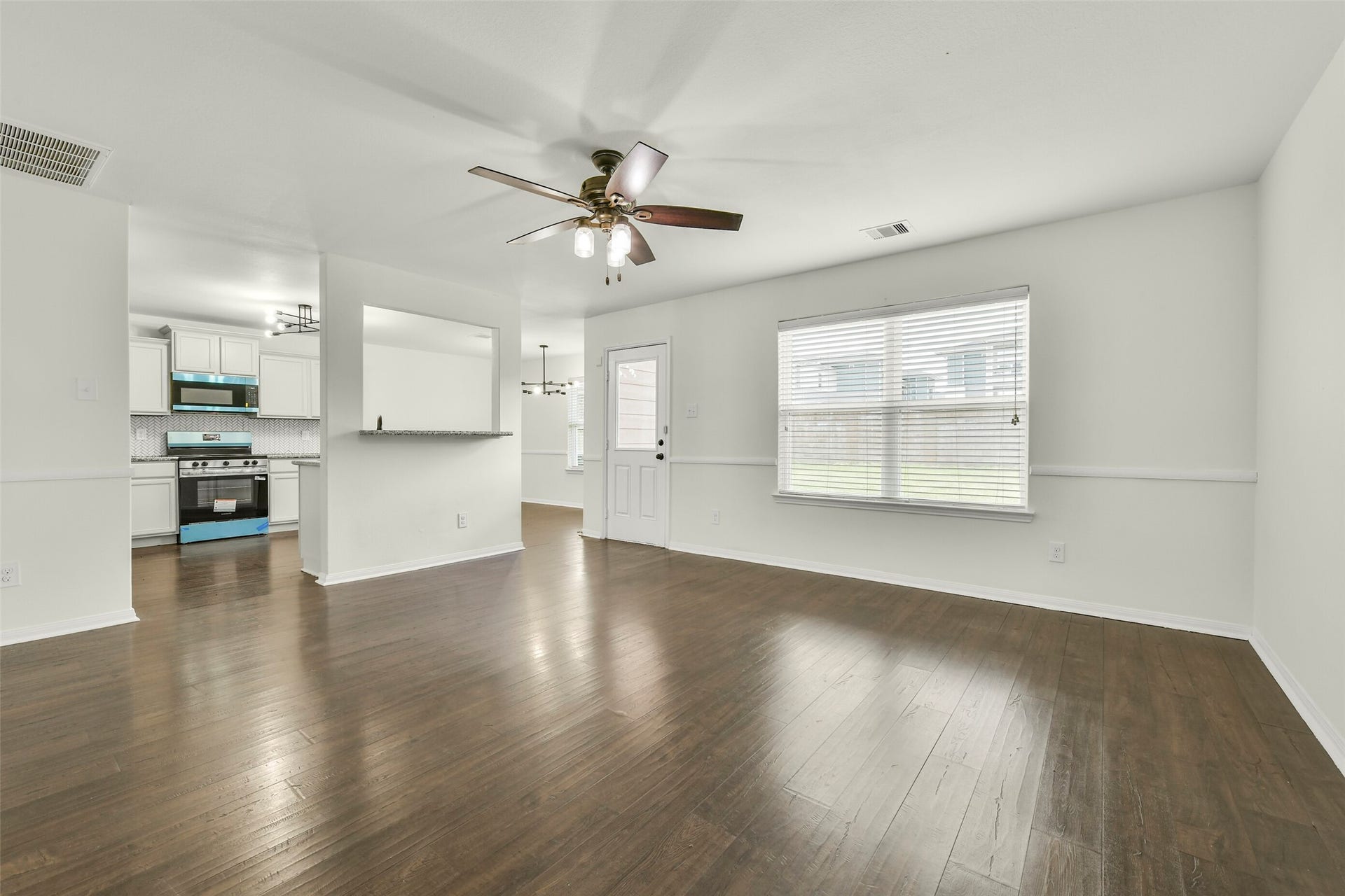 2921 Seacrest Lane, La Marque, TX 77568 Open-concept living area with abundant natural light and seamless flow into dining and kitchen spaces.