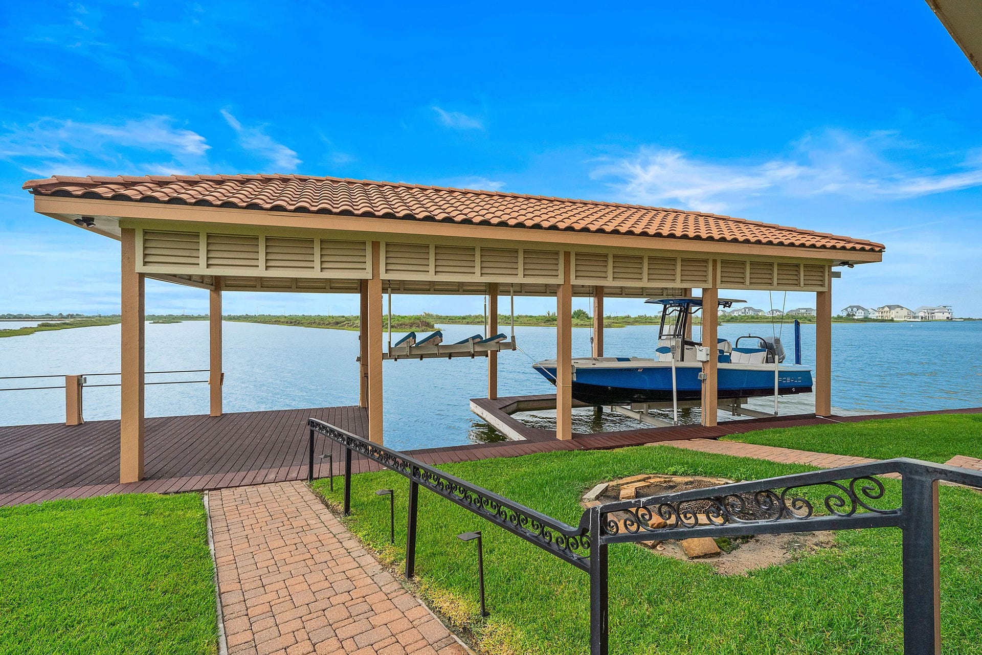 21 Loggerhead, Hitchcock, TX 77563 Follow the paver pathway to your large boathouse equipped with boat and jet ski lifts, along with dock space perfect for fishing, relaxing, and enjoying waterfront views