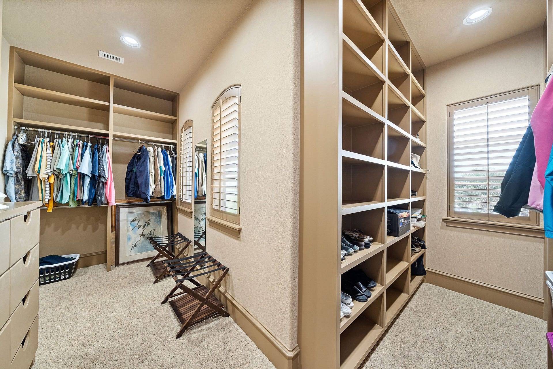 21 Loggerhead, Hitchcock, TX 77563 With custom built-in cabinetry, the primary bedroom closet is a perfect blend of luxury and practicality, offering abundant storage and a sleek, tailored look