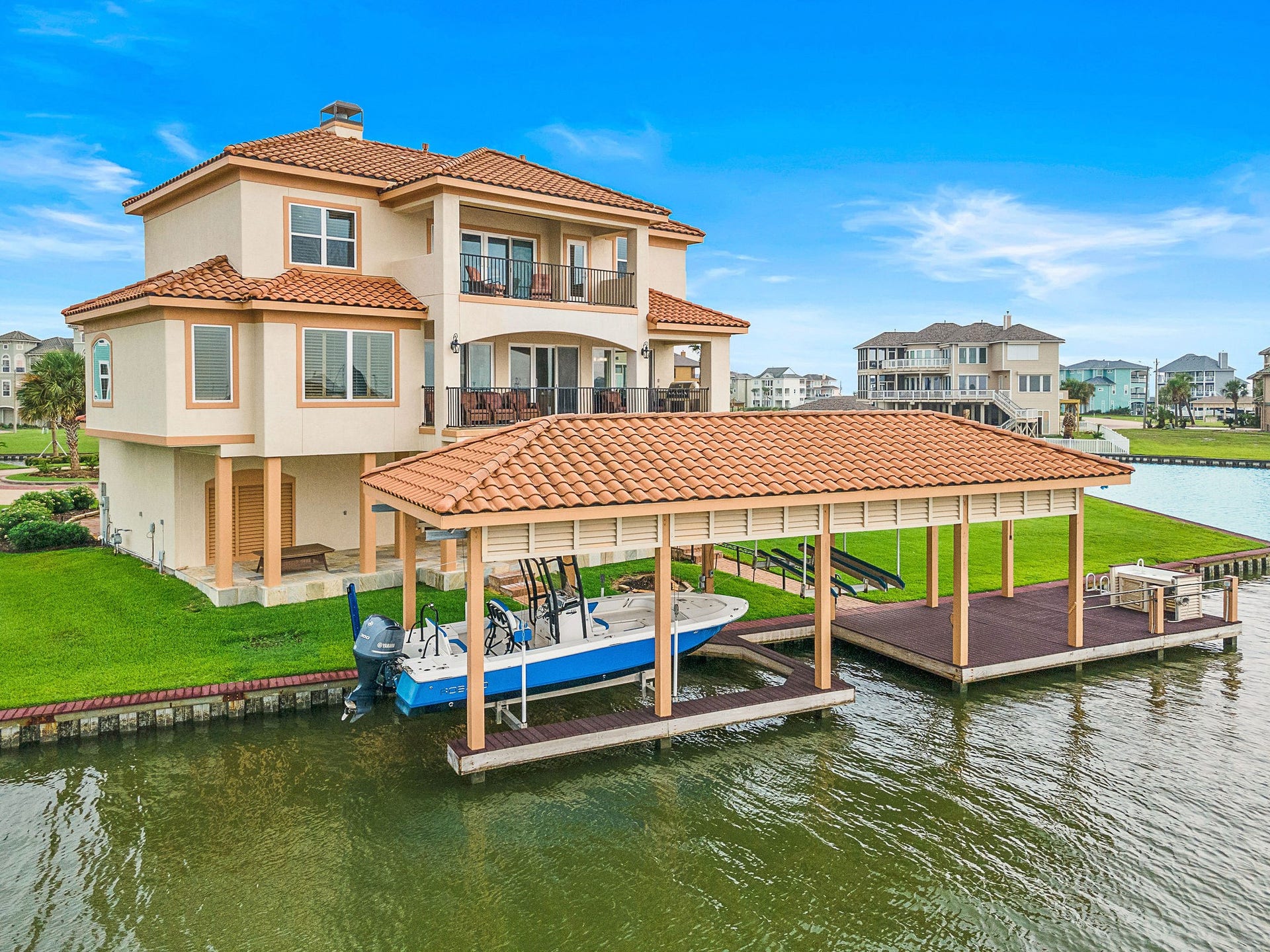 21 Loggerhead, Hitchcock, TX 77563 This Mediterranean-style waterfront home blends coastal elegance with relaxed luxury. With terracotta roof tiles, stucco exterior, and spacious balconies, it offers stunning canal views. Highlights include a covered patio, upper terrace, private boat slip with lift, and beautifully landscaped groundsperfect for indoor-outdoor living and entertaining