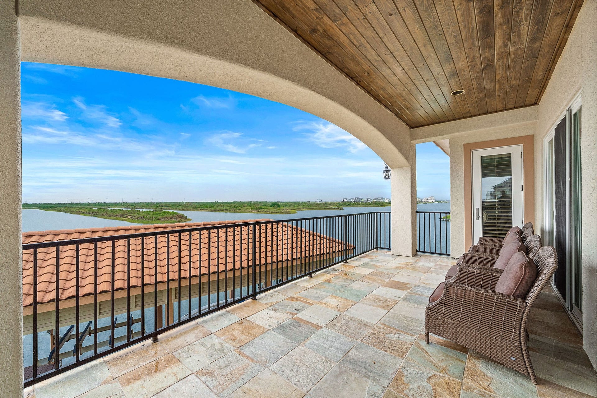 21 Loggerhead, Hitchcock, TX 77563 Enjoy seamless indoor-outdoor living as the living room, kitchen, and primary suite all offer access to a covered terrace overlooking the Marina Channel and West Bay