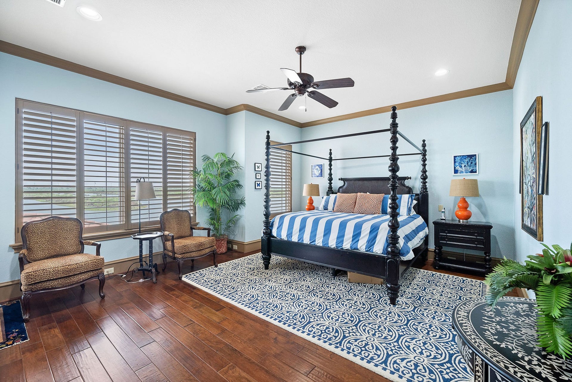 21 Loggerhead, Hitchcock, TX 77563 The large primary suite offers beautiful hardwood flooring and captivating waterfront views
