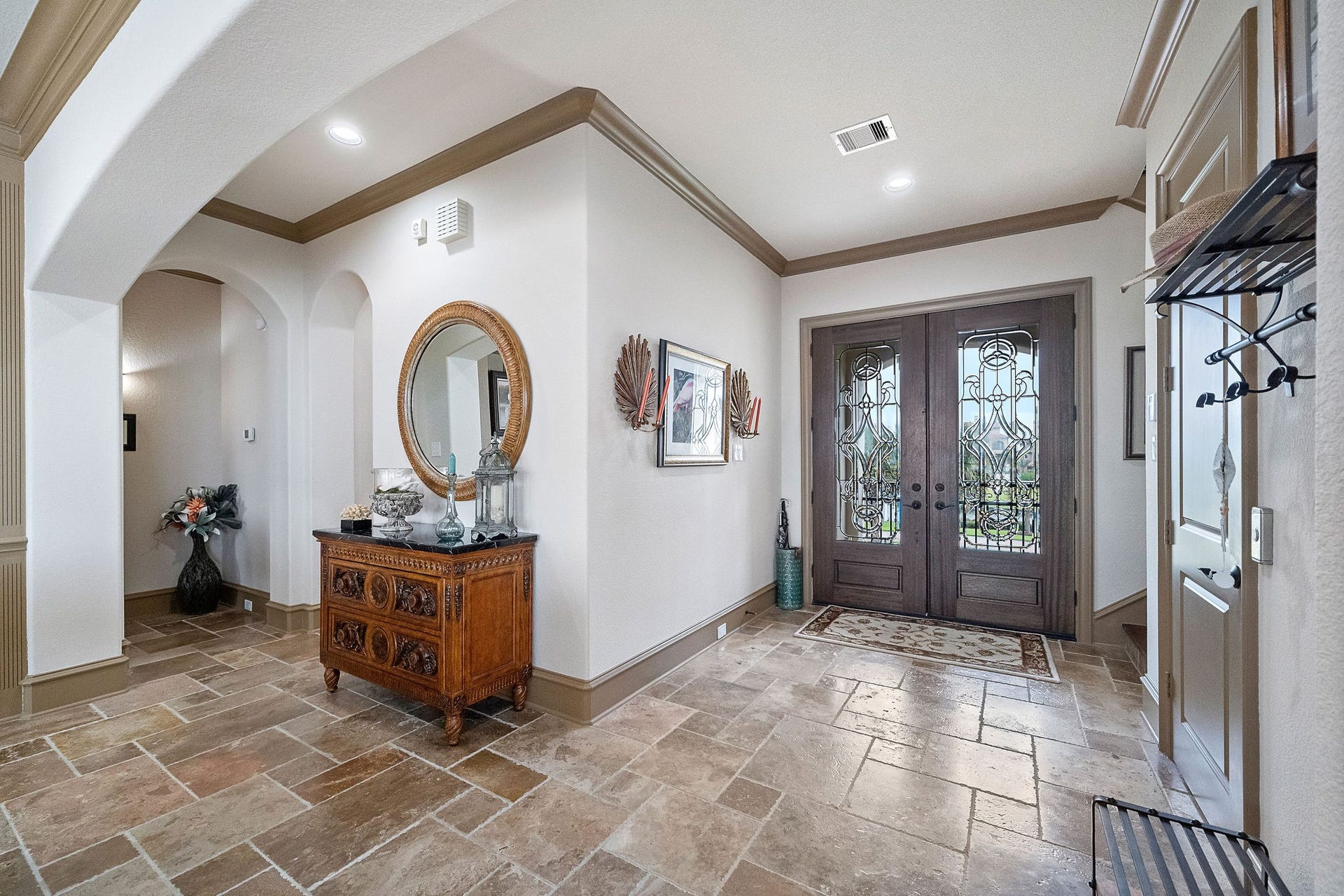 21 Loggerhead, Hitchcock, TX 77563 A welcoming travertine entrance with elevator to the right side of the photo. The elevator reaches all levels for convenience