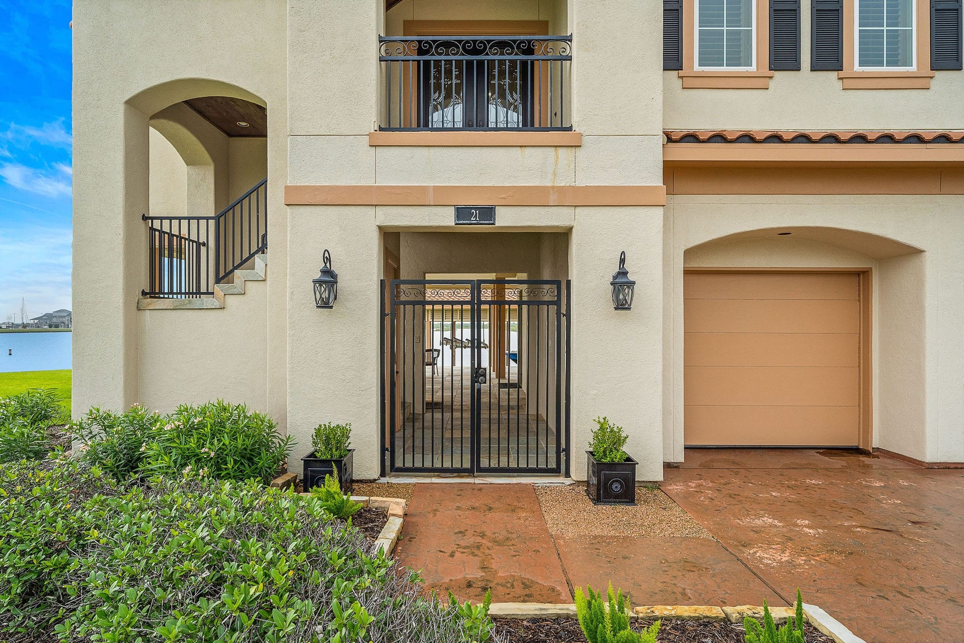 21 Loggerhead, Hitchcock, TX 77563 This waterfront home offers a ground-level entry framed by lush landscaping. Pass through the wrought-iron gates to the left, leading to the entry stairway, or continue straight to the dockside living area on the ground level