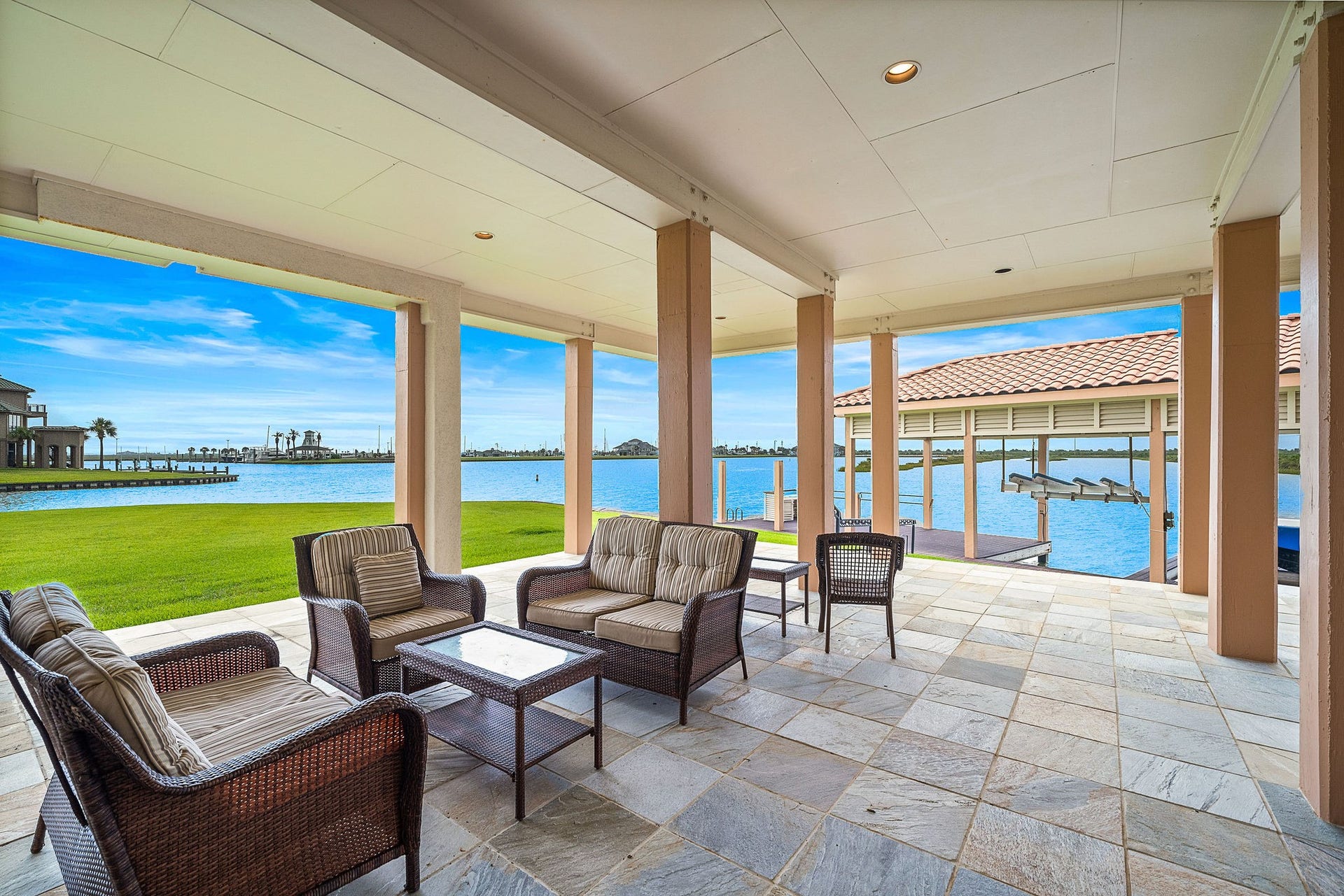 21 Loggerhead, Hitchcock, TX 77563 The ground-level dockside living offers effortless access to the water, with spacious, open areas designed for relaxation and enjoying the scenic waterfront surroundings