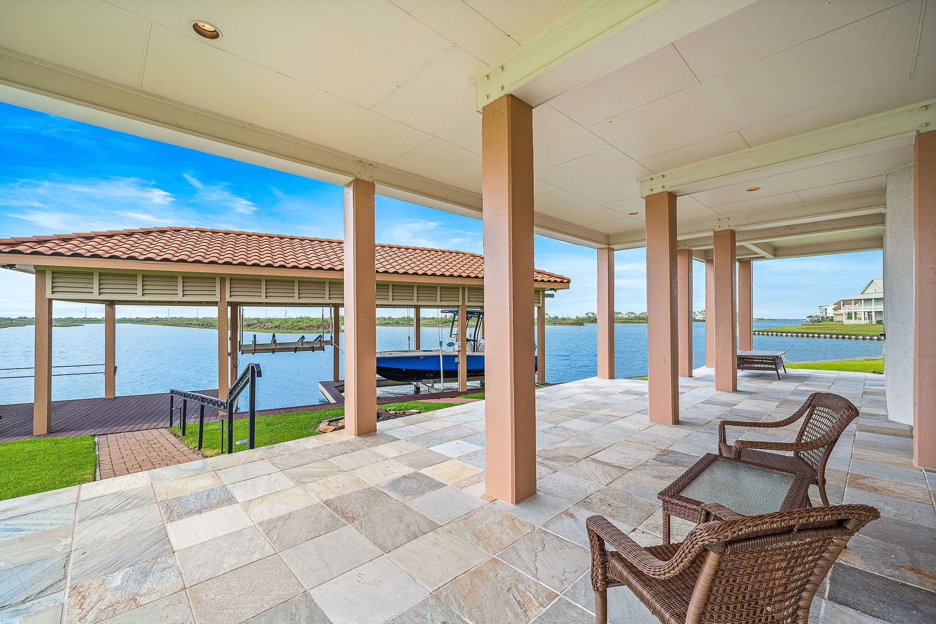 21 Loggerhead, Hitchcock, TX 77563 This home provides access to the backyard boathouse, with a direct path from the home leading to the water, making it ideal for boating and waterfront relaxation