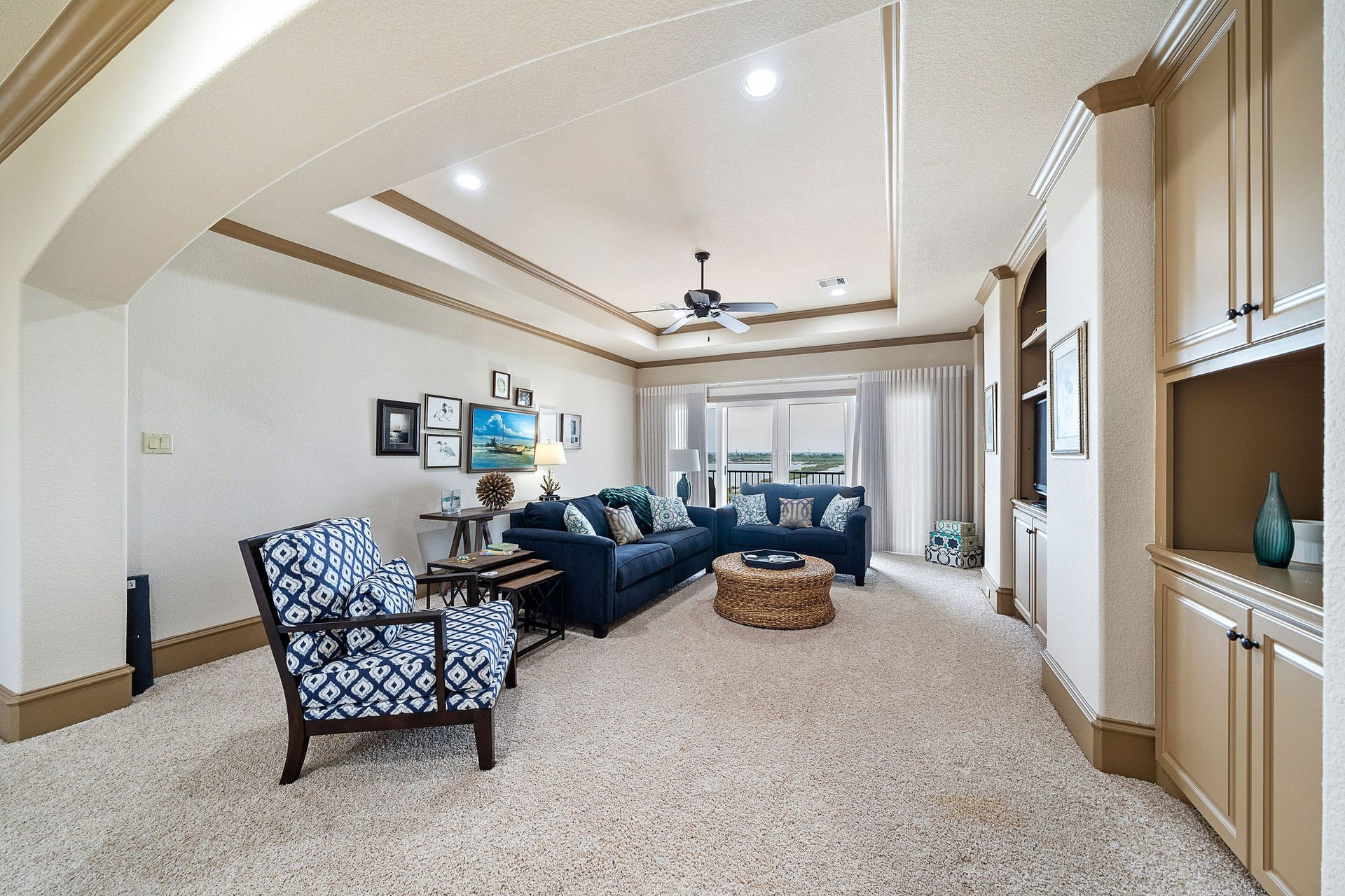 21 Loggerhead, Hitchcock, TX 77563 This expansive game/media room on the upper level provides convenient access to the third-floor terrace, creating an ideal space for both indoor and outdoor enjoyment