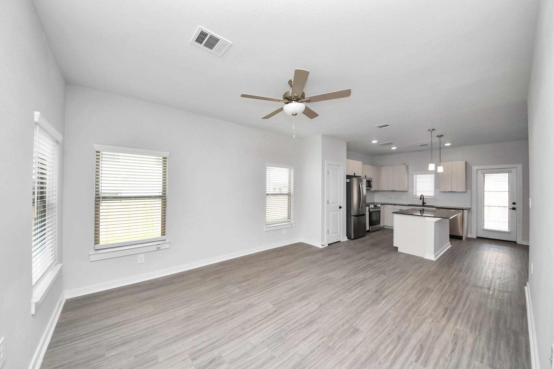 Boasting luxury finishes-stylish Island kitchen,granite counters,subway tile backsplash,ample custom cabinet space,stainless appliances,refrigerator,full size washer&dryer included,wood-like flooring throughout,open concept floor plan.