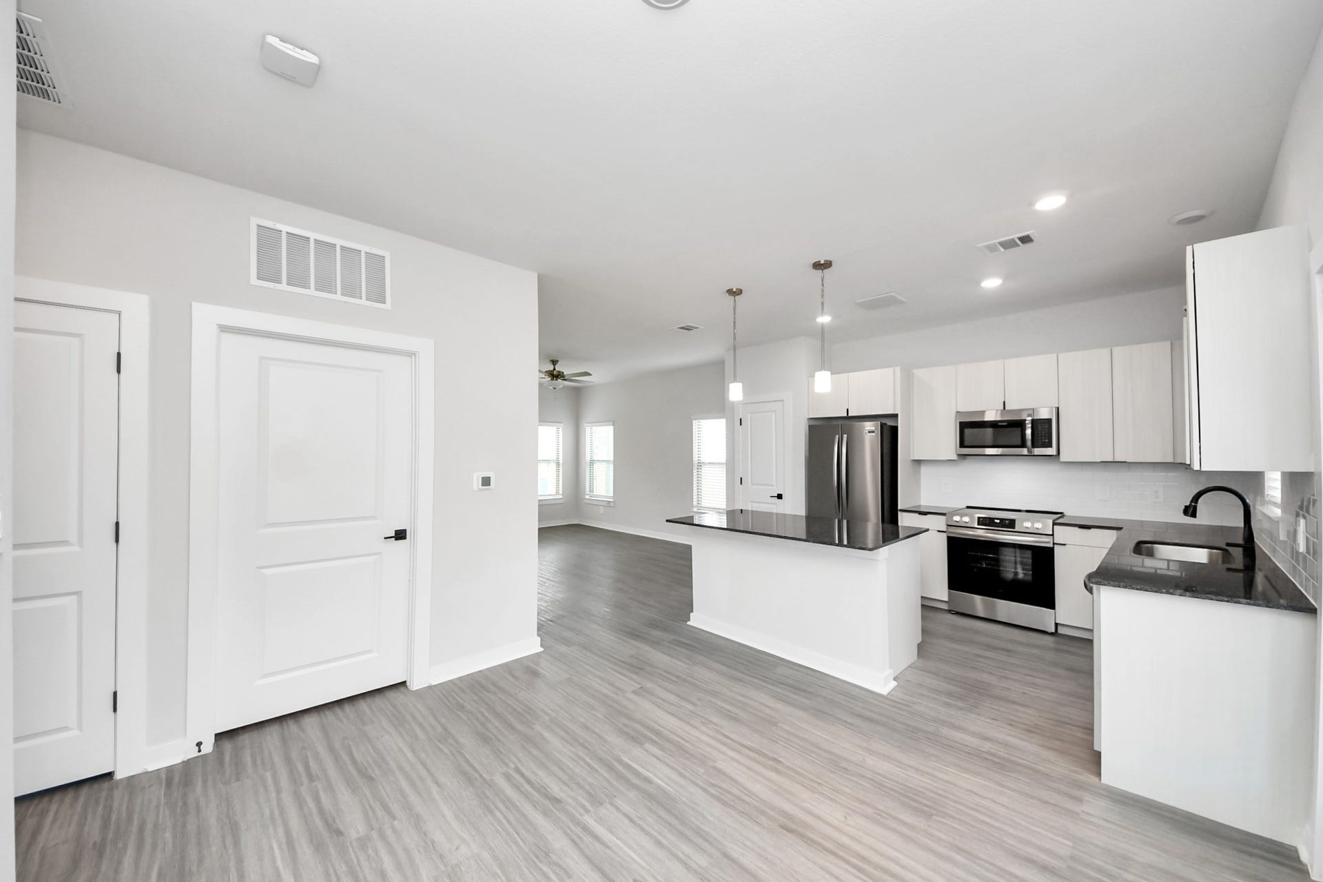 Boasting luxury finishes-stylish Island kitchen,granite counters,subway tile backsplash,ample custom cabinet space,stainless appliances,refrigerator,full size washer&dryer included,wood-like flooring throughout,open concept floor plan.