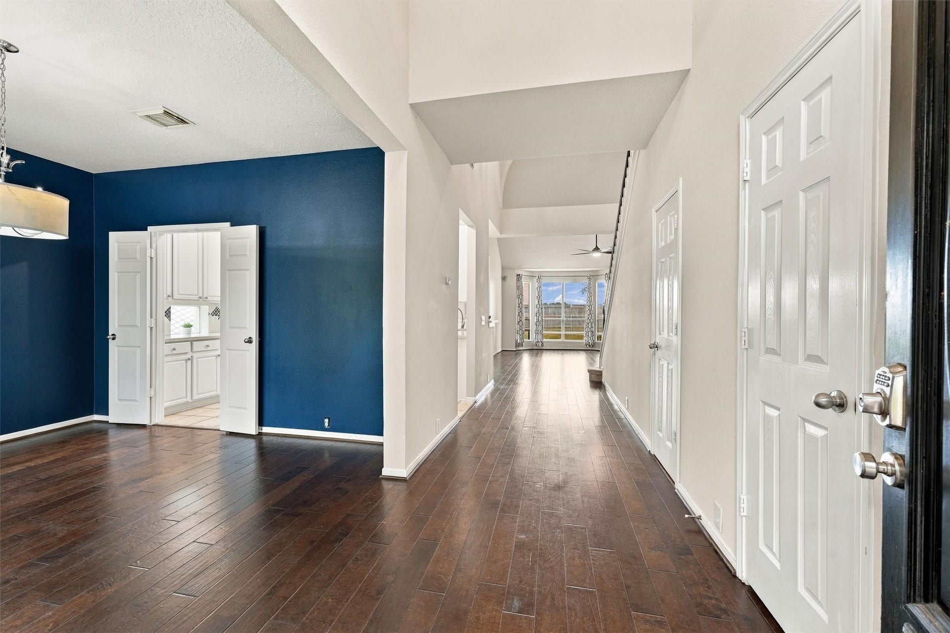 Spacious formal dining room featuring engineered hardwood flooring and elegant architectural details.