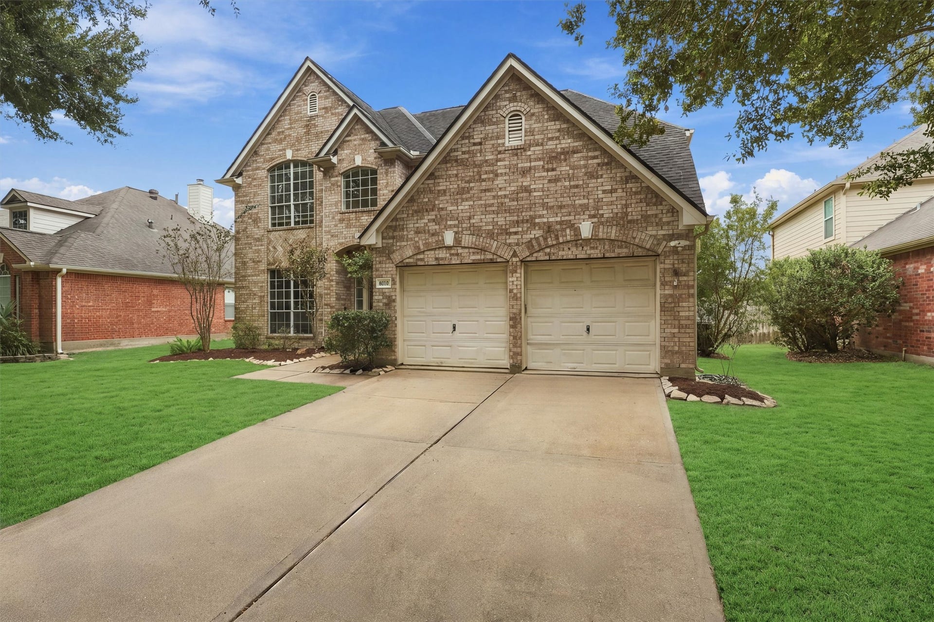 Charming brick exterior with an attached two car garage and inviting curb appeal.