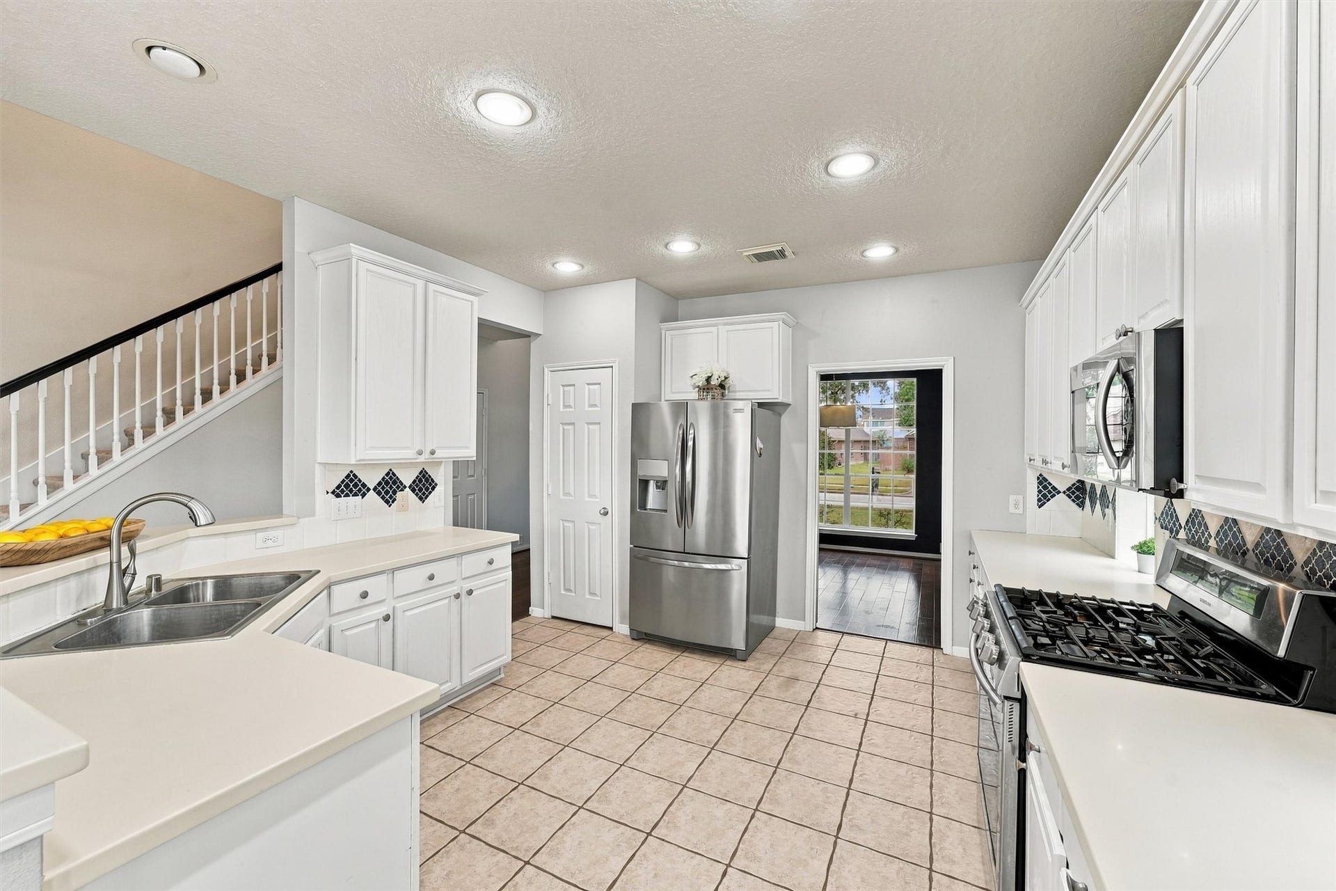 Spacious kitchen with a breakfast bar, ample cabinetry, and convenient access to the living areas.