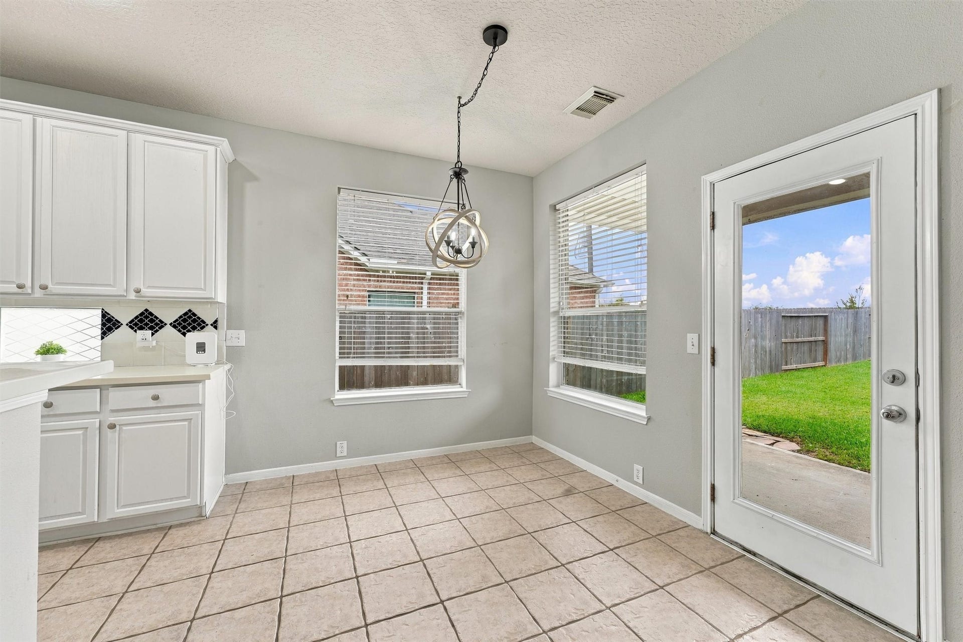 Light filled breakfast area overlooking the backyard with convenient access to the covered patio.