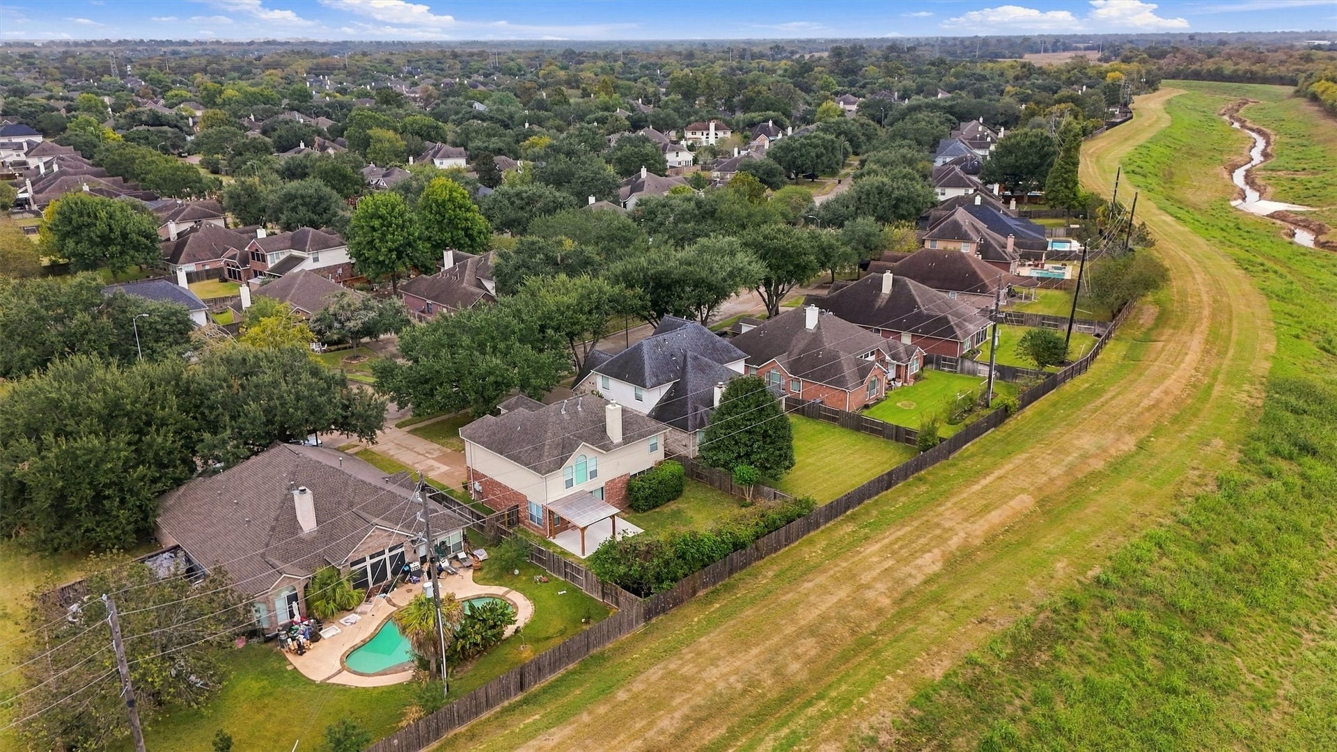 Aerial neighborhood view showcasing nearby greenbelt space and surrounding homes.