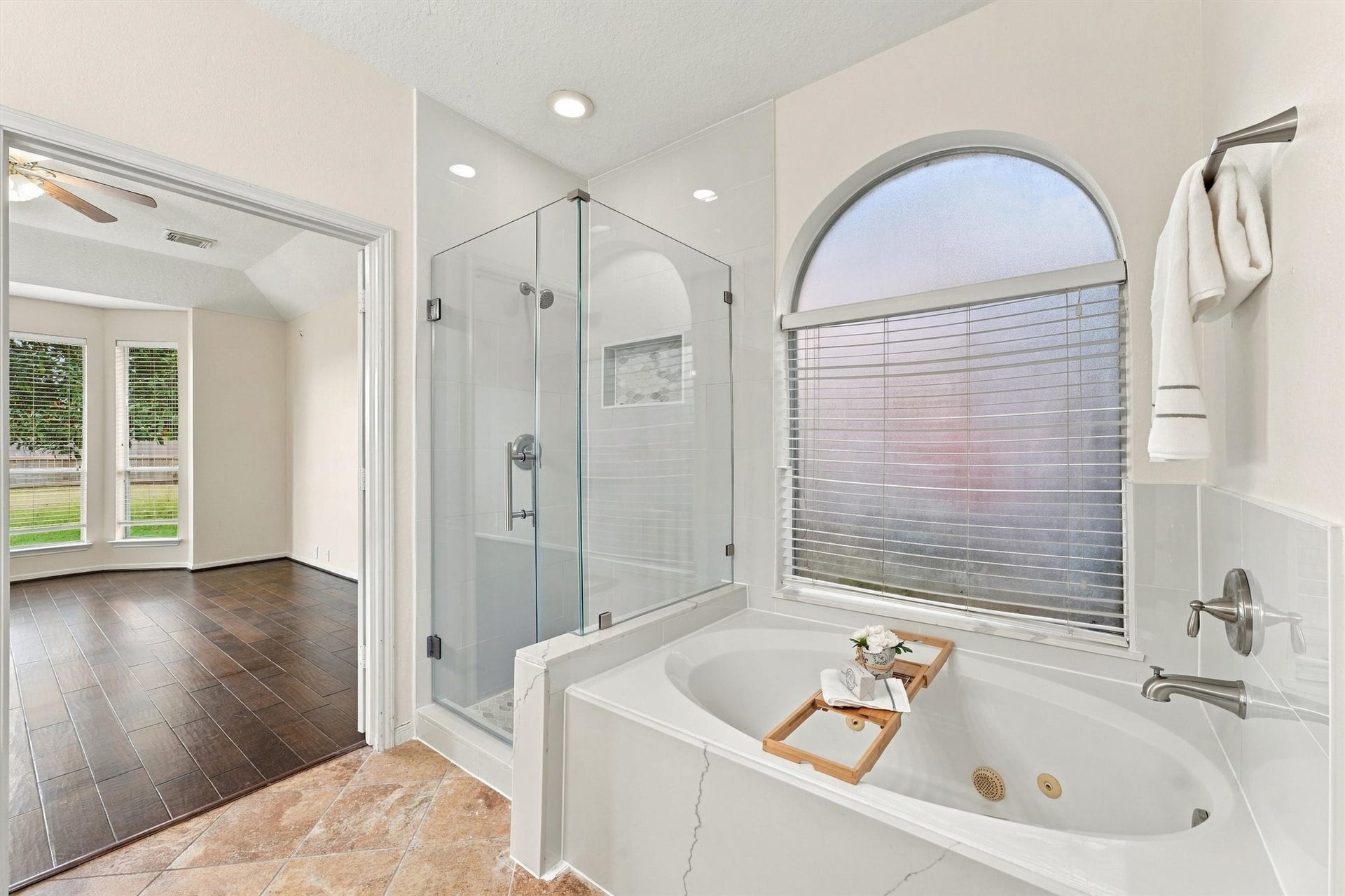 Another view of the primary bathroom showcasing the separate shower and relaxing jetted tub.