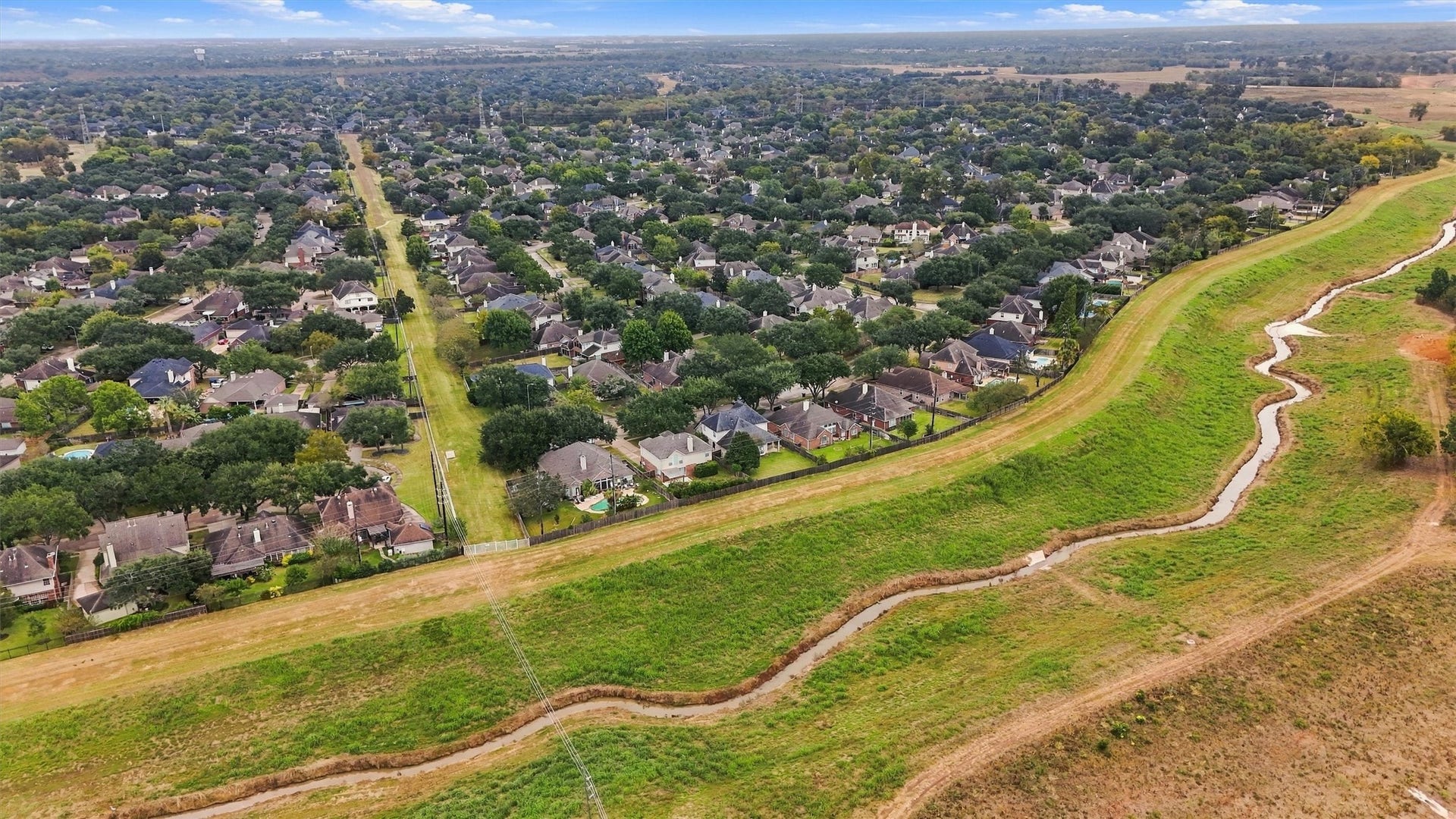 Aerial view highlighting the home's convenient location near greenbelt space.