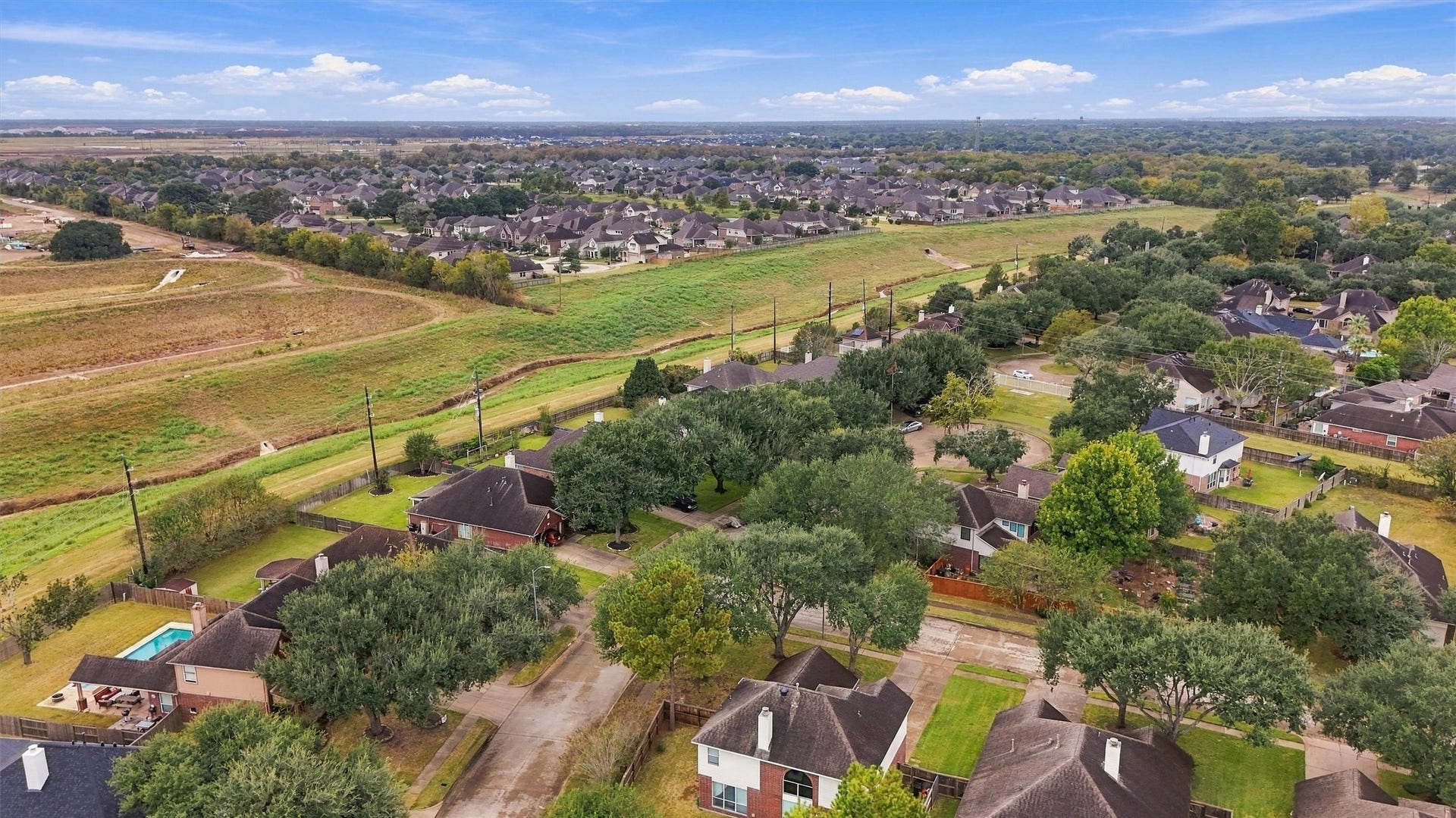 Another aerial view highlighting the neighborhood's green spaces and convenient location.