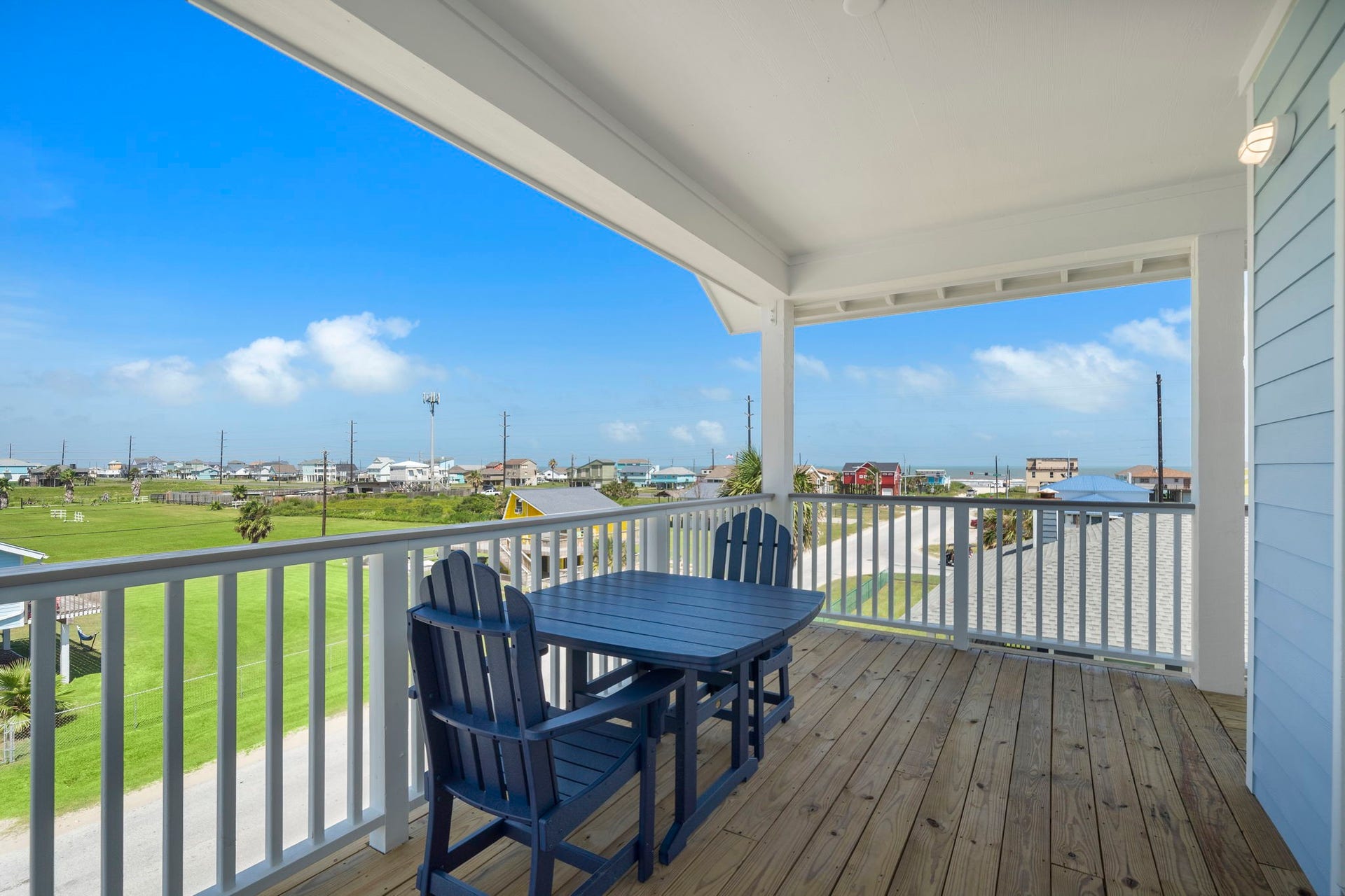 Enjoy stunning coastal views from this spacious, covered deck, perfect for outdoor dining and relaxation.