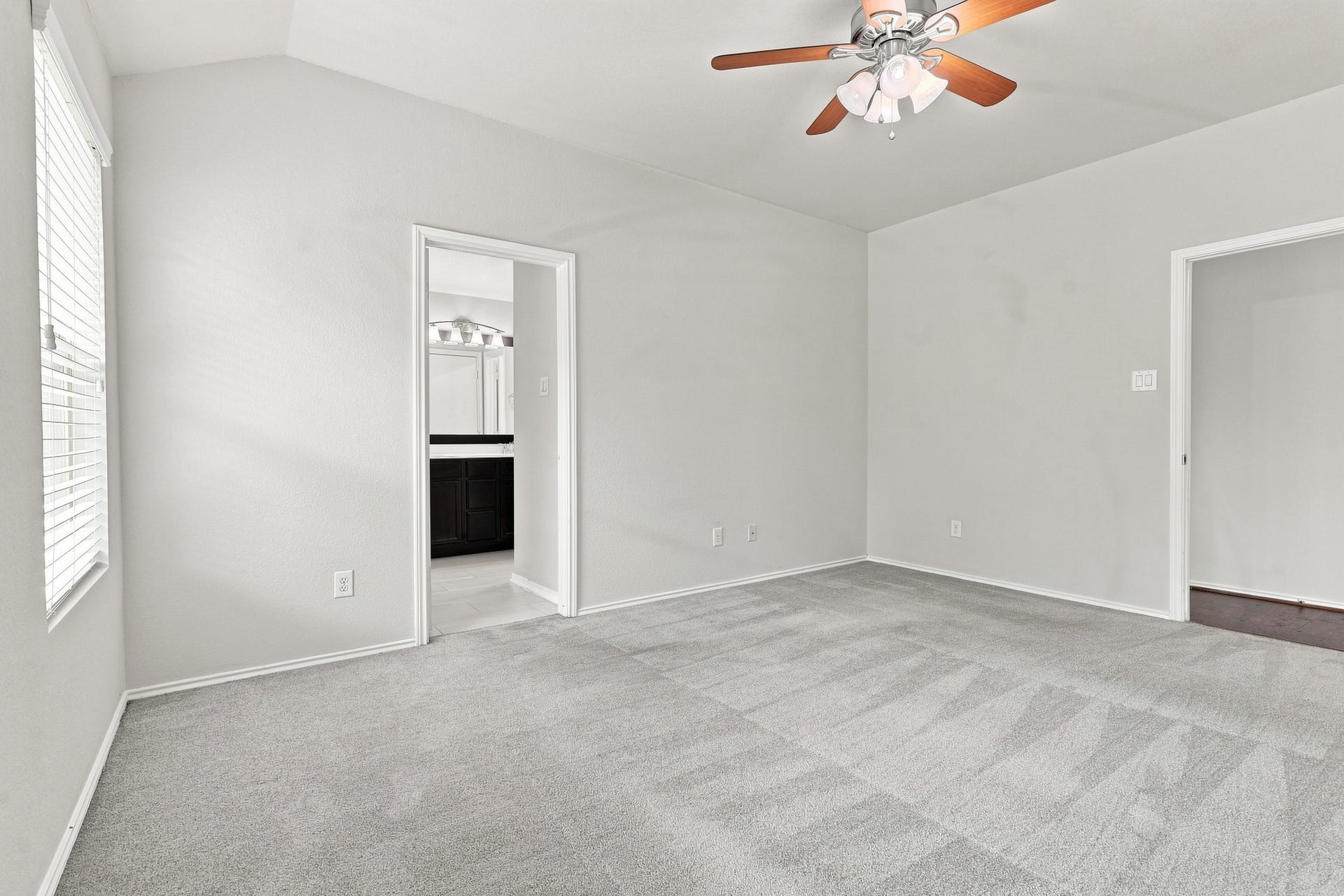 Additional primary bedroom view with direct access to the en-suite bathroom.