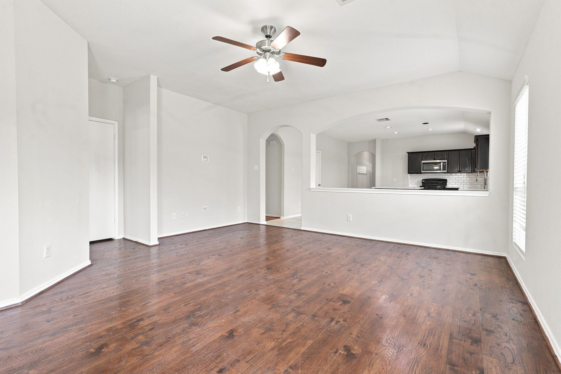 15. Additional living room view showcasing the open layout and pass-through to the kitchen and dining area.