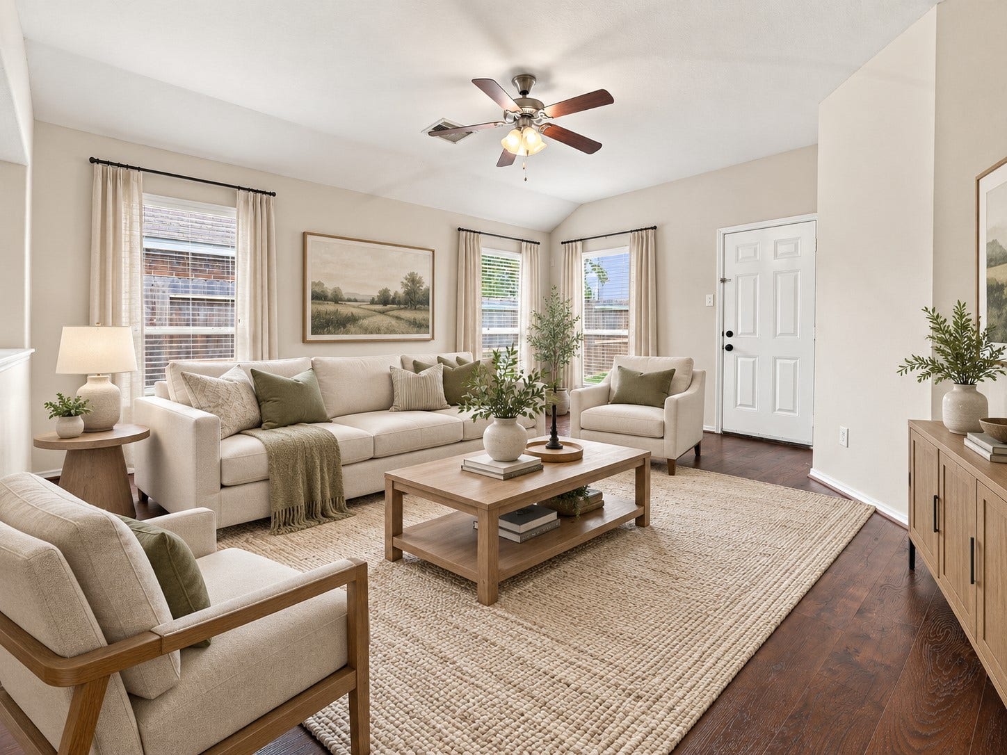 Spacious living room with upgraded flooring, ceiling fan, and a bright, open layout. Virtually staged.