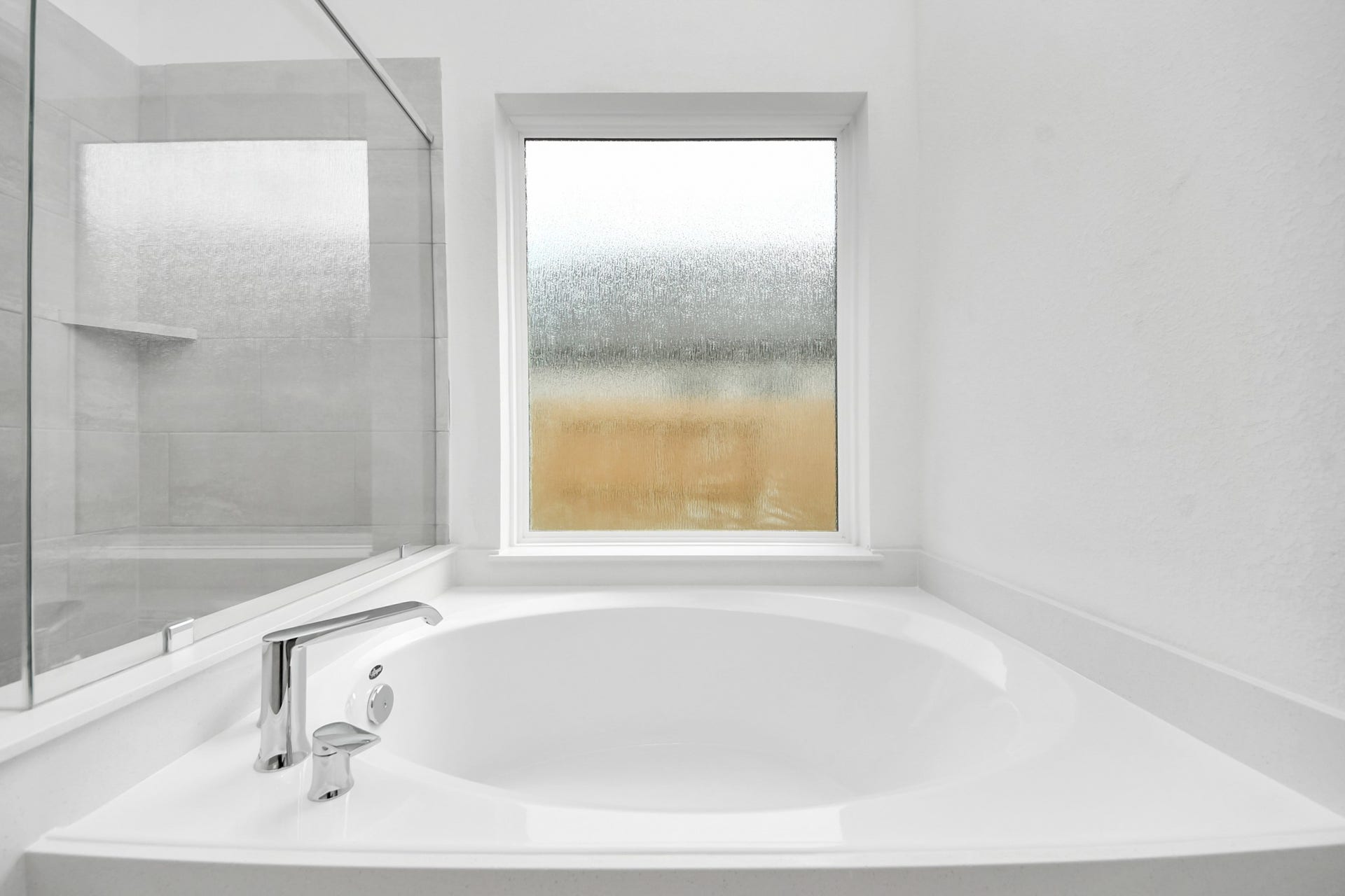Indulge in a spa-like retreat within the confines of this primary bathroom. Delight in a spacious walk-in shower enveloped in stylish tile surround, unwind in a separate garden tub adorned with custom detailing.