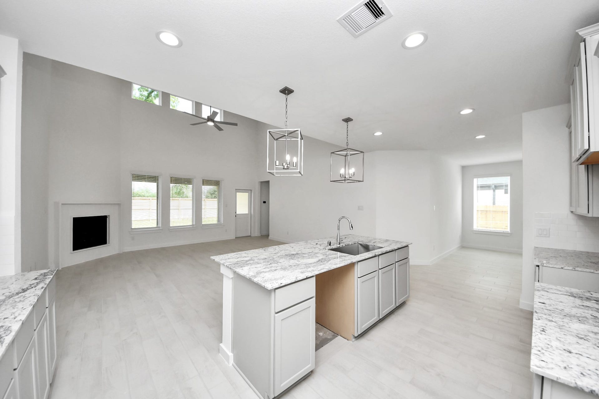 The open concept effortlessly connects the kitchen to the expansive family room, forming a perfect hub for gatherings. This seamless flow creates an inviting space where cooking and socializing come together harmoniously.