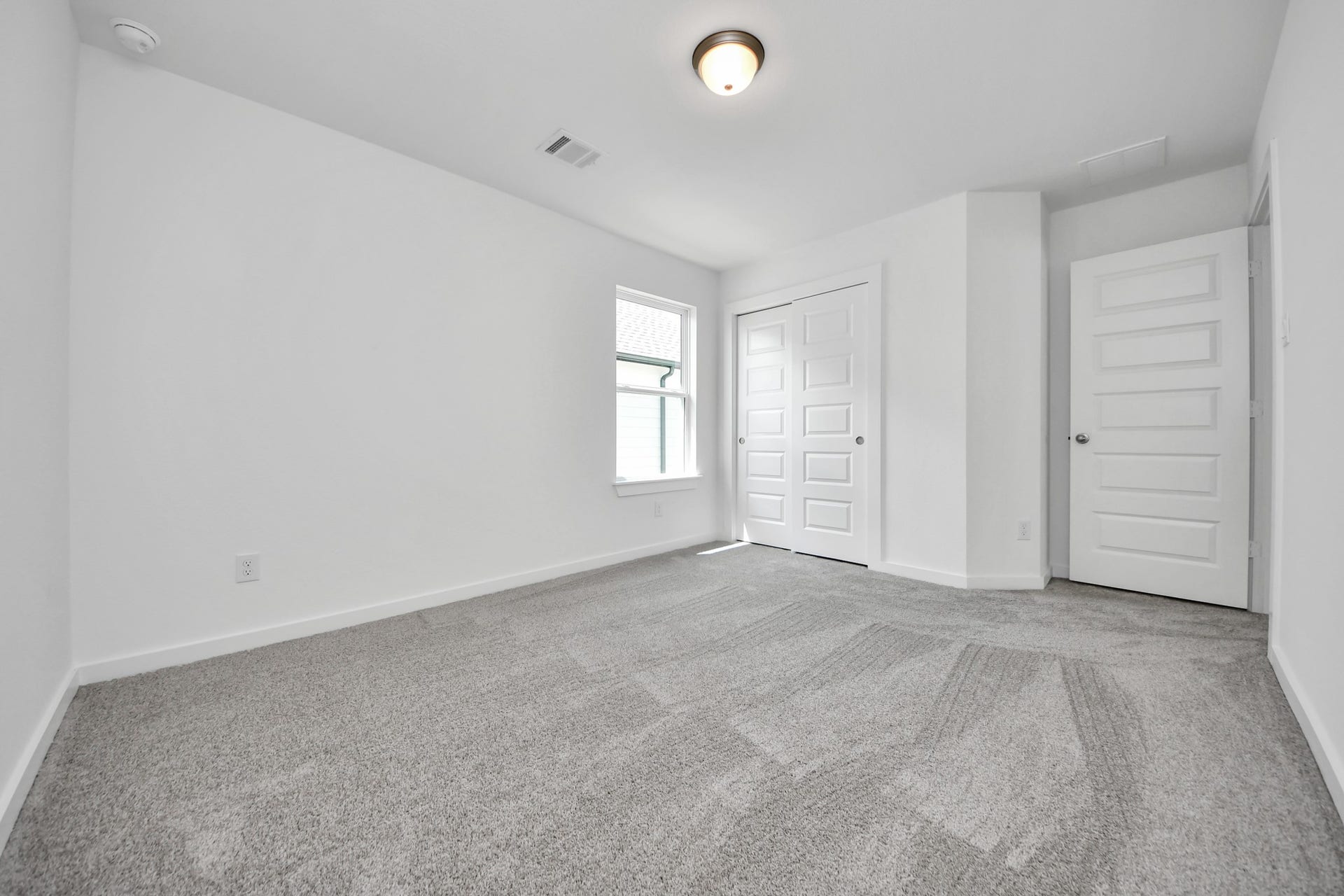Generously sized secondary bedrooms featuring spacious closets, soft and inviting carpeting underfoot, large windows allowing plenty of natural light, and the added touch of privacy blinds for your personal retreat. Sample photo of completed home with similar floor plan. Actual colors and selections may vary.